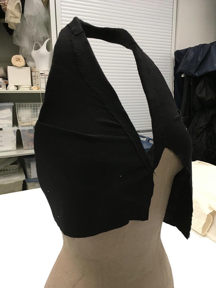 Black papier-mâché mount for a halter dress with a v-neck