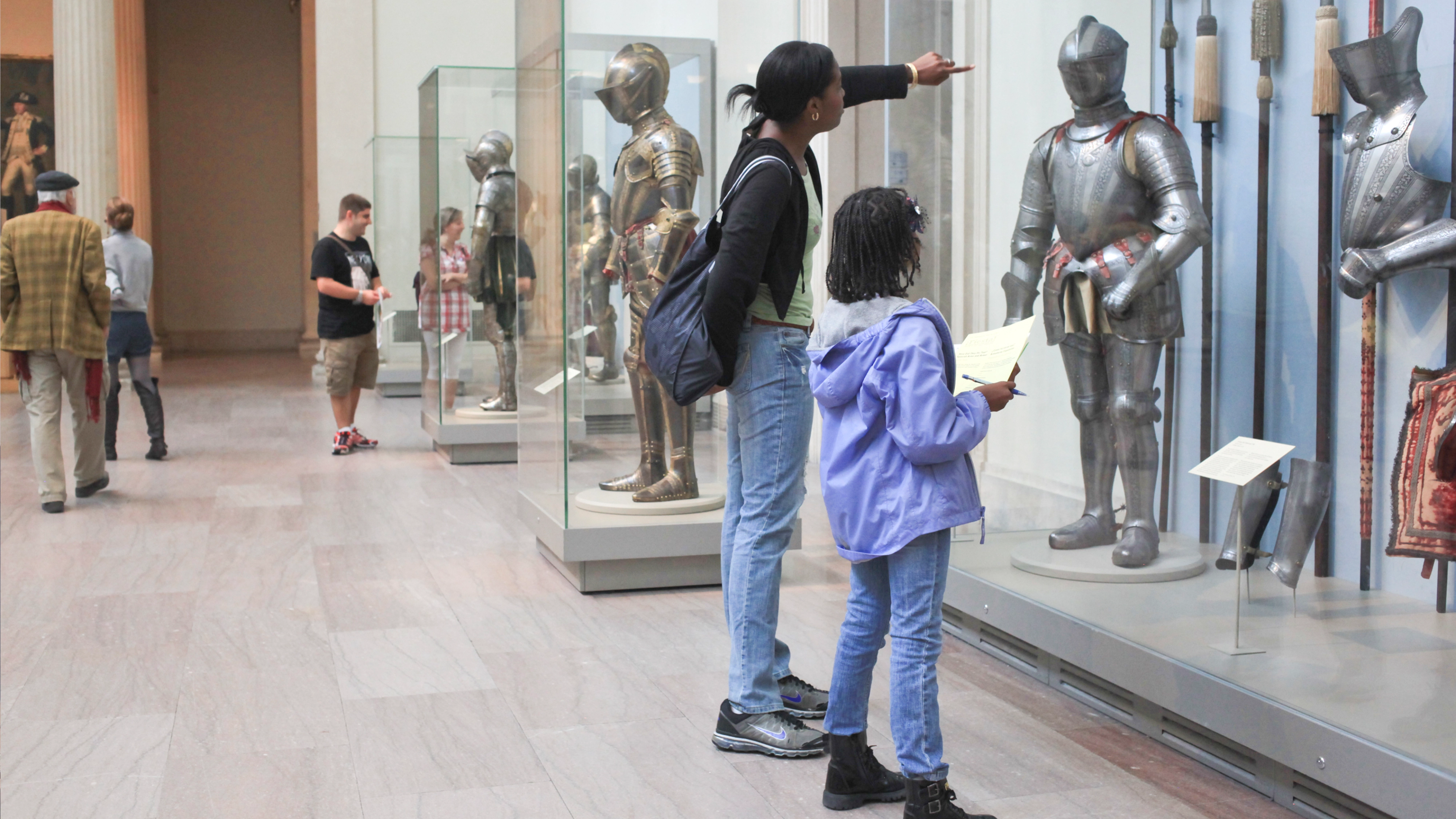 A mom and daughter looking at the Arms & Armor galleries. 