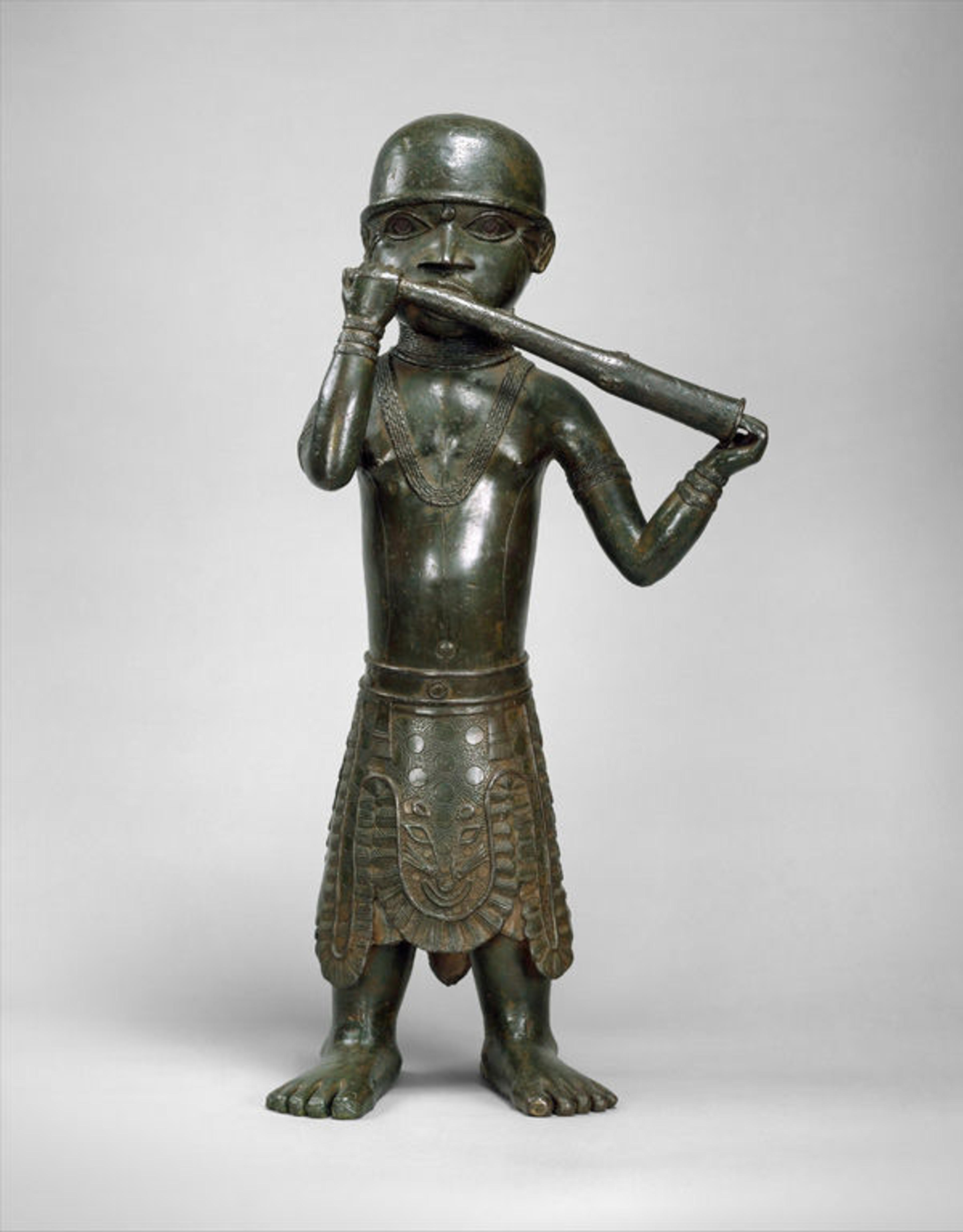 Figure: Horn Player, 1550–1680. Nigeria, Court of Benin. Edo peoples. Brass; H. 24 13/16 x W. 11 9/16 x D. 6 3/4 in. (63 x 29.4 x 17.2 cm). The Metropolitan Museum of Art, New York, The Michael C. Rockefeller Memorial Collection, Gift of Nelson A. Rockefeller, 1972 (1978.412.310)