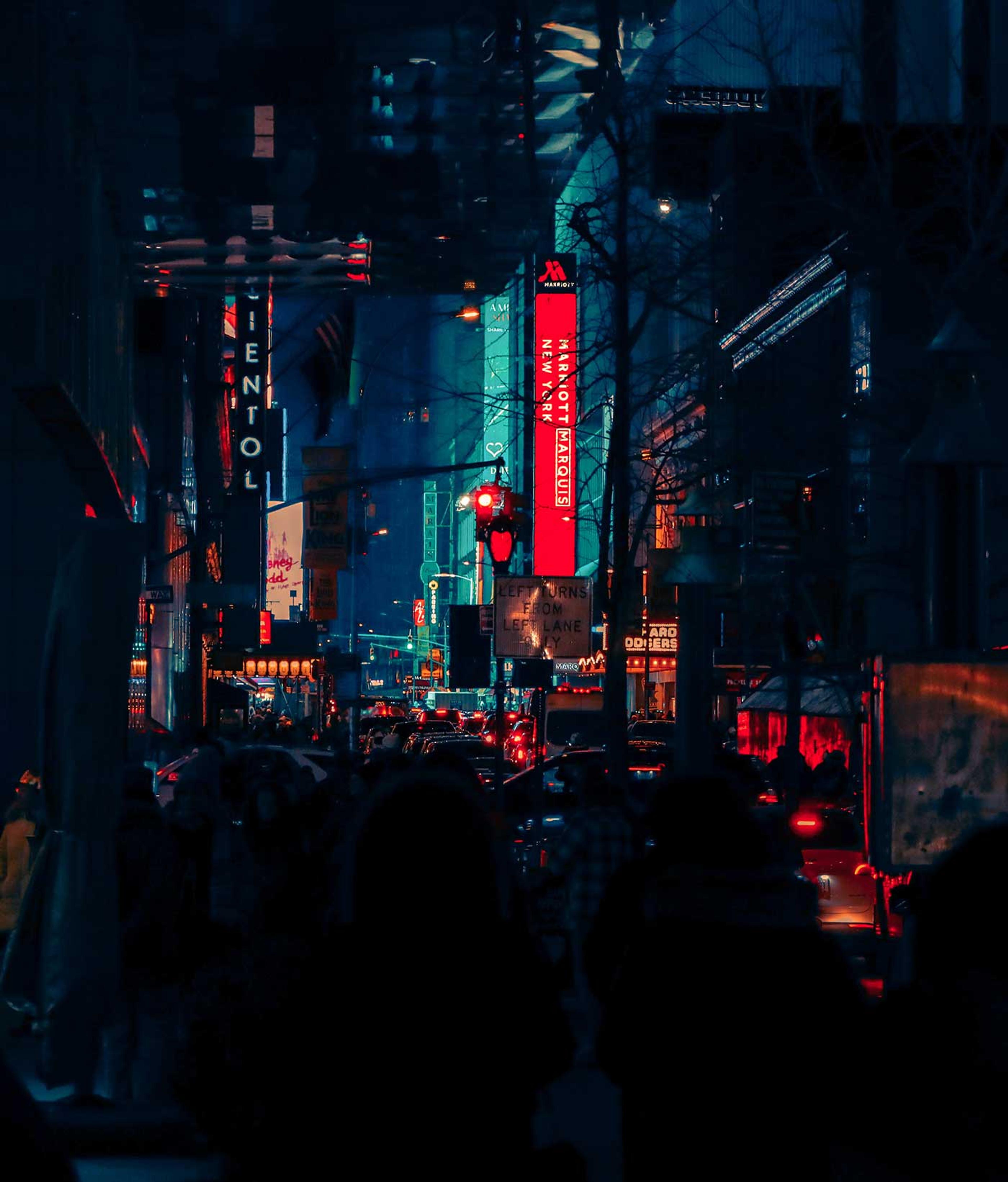 Digital photograph of a city street at night.