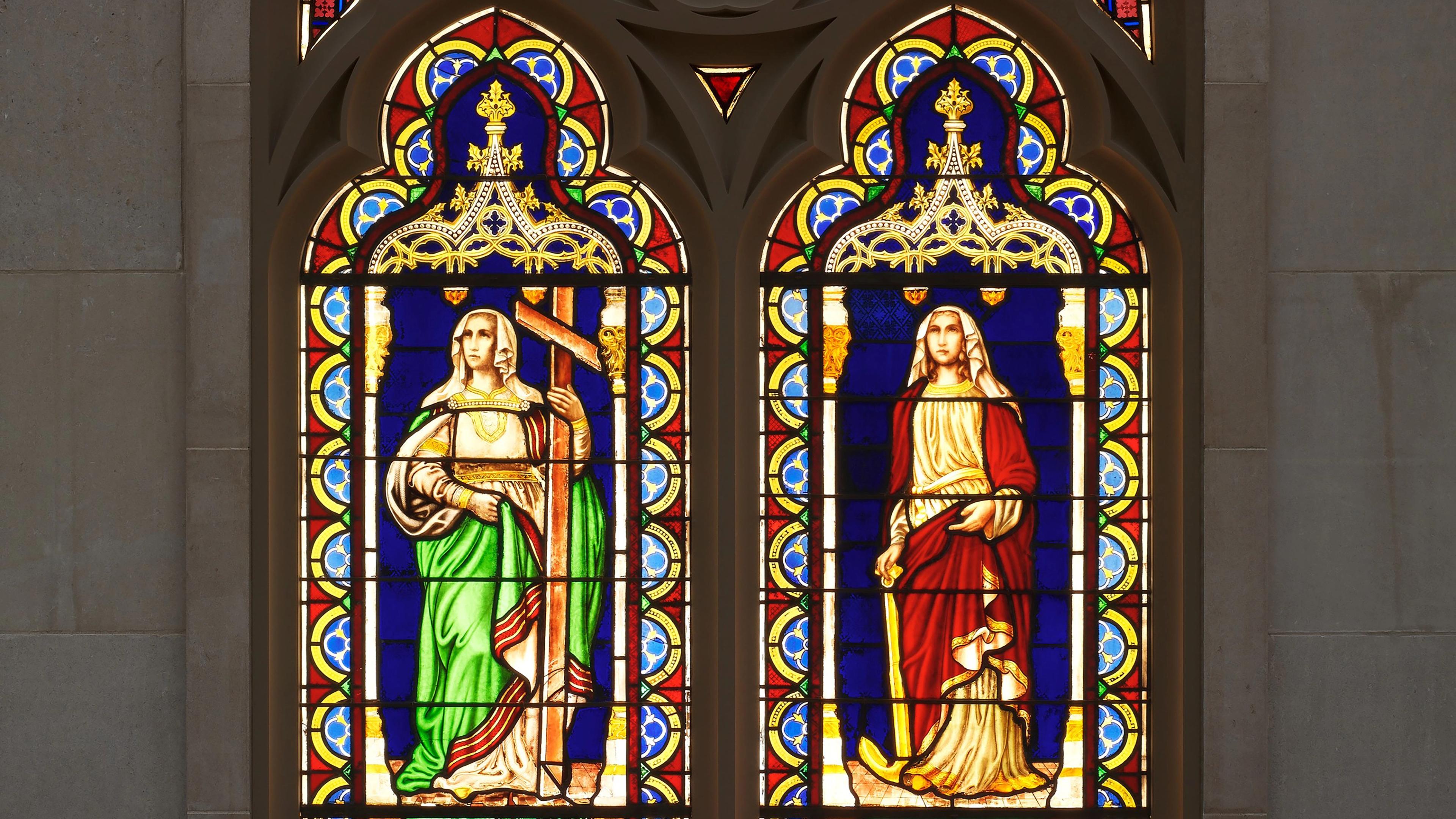 A double lancet stained-glass window depicting the personifications of "Faith and Hope" by the American artist Henry E. Sharp.