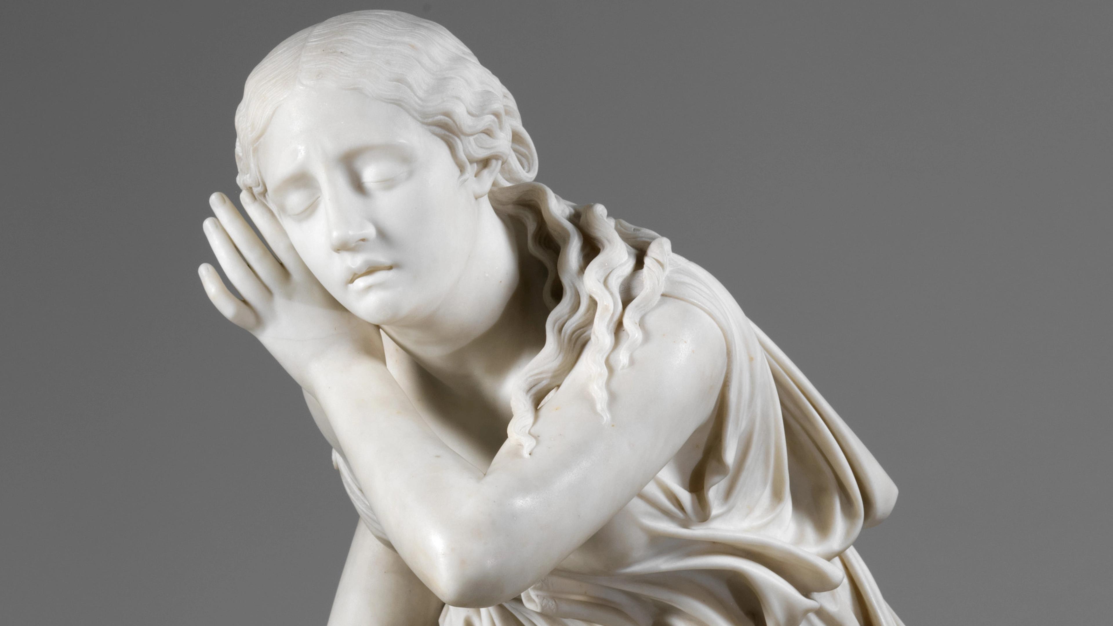 Marble sculpture of a girl, her eyes closed and her hand raised to her ear.