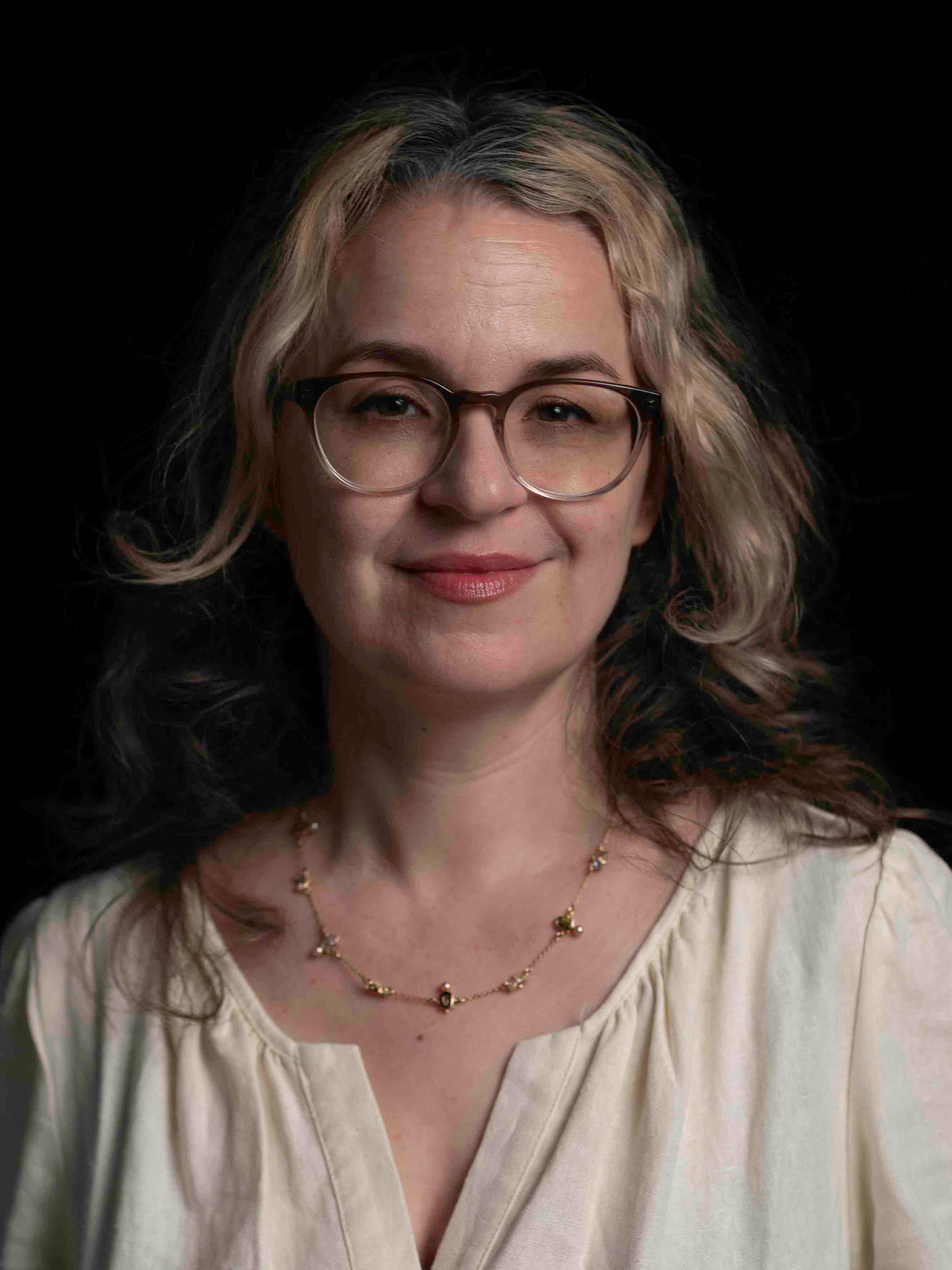 Headshot of Christina Amato against a solid black background