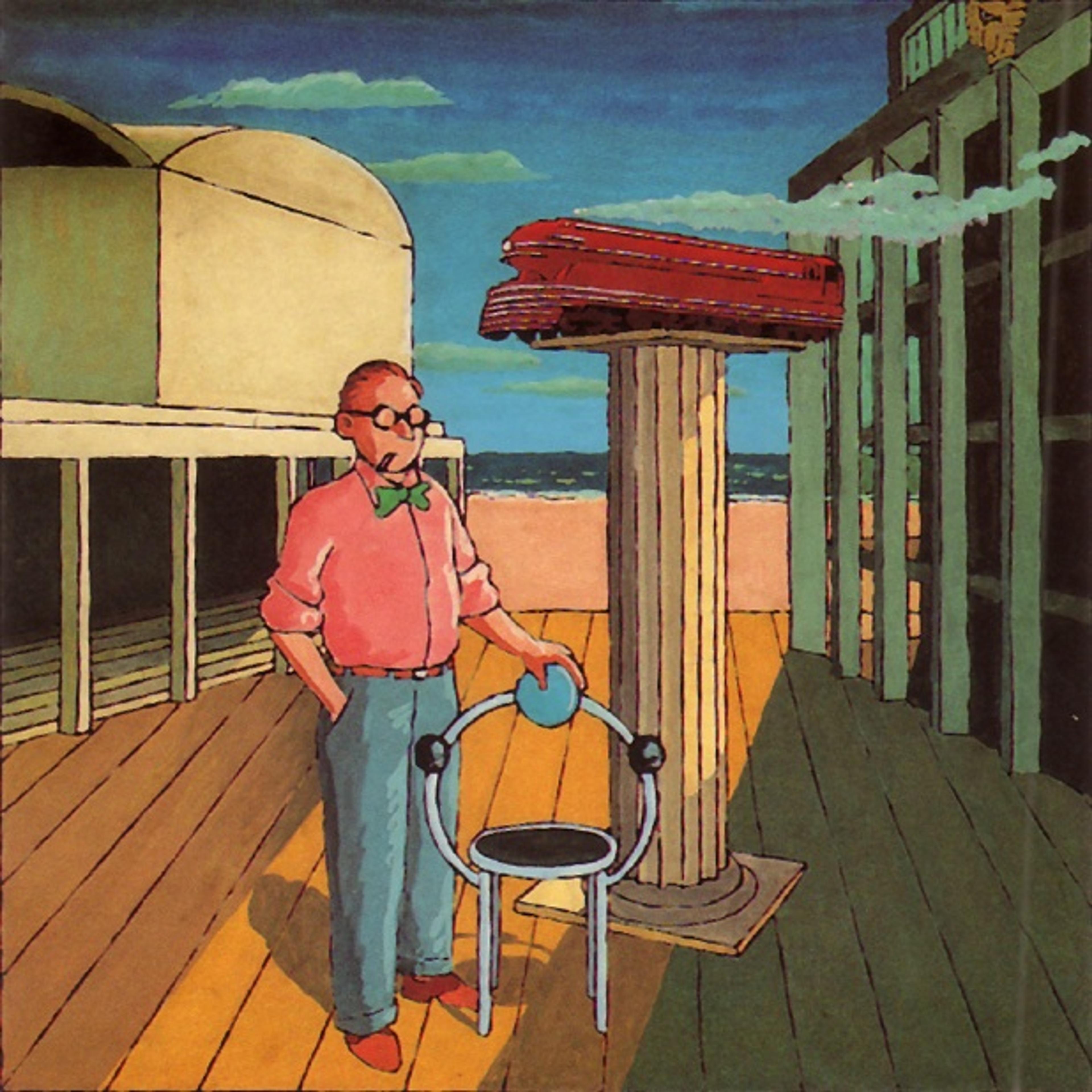 IMage of man standing on a pier on the beach, with his left hand resting on a metal chair. 