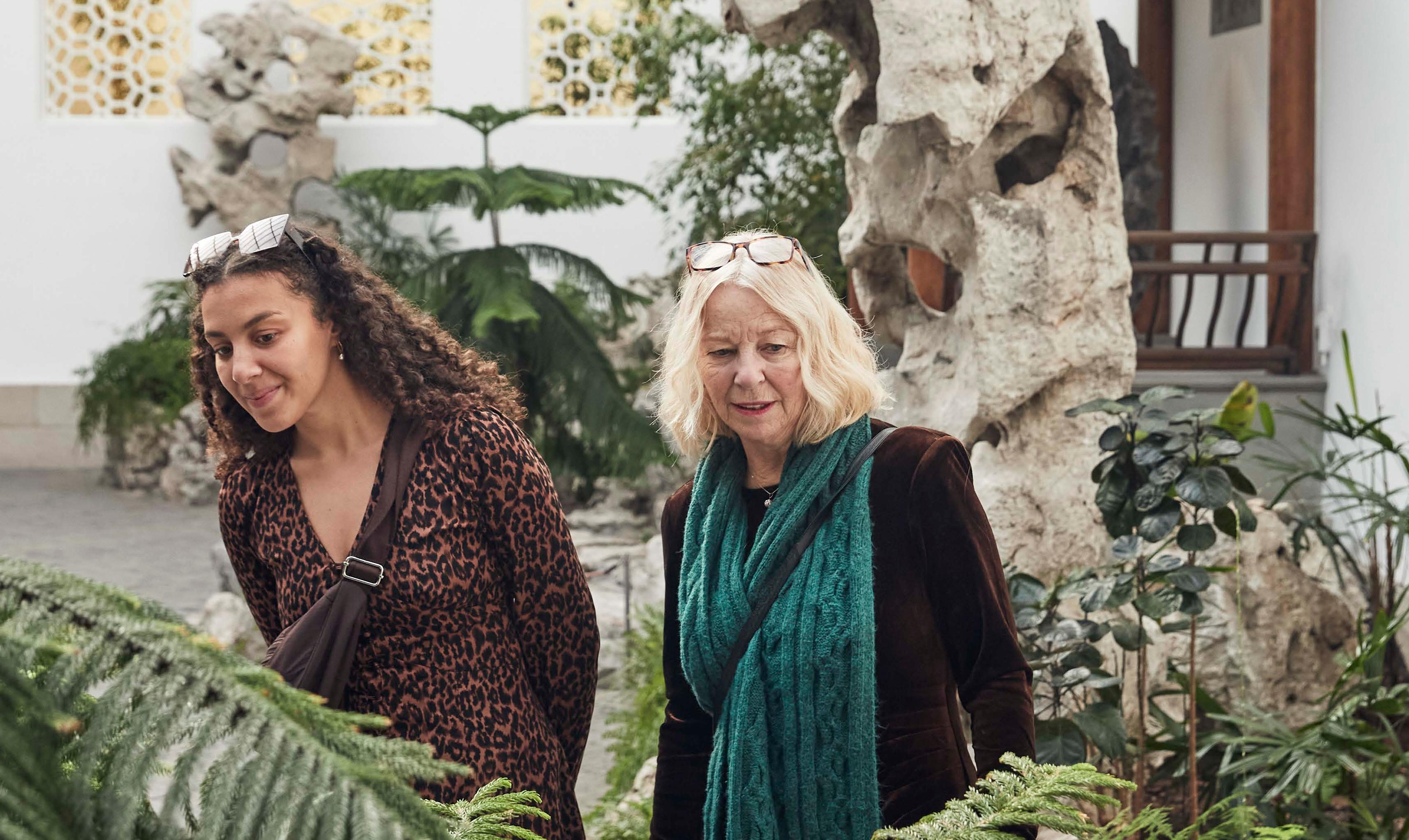 Two women look at their surroundings in The Met's Chinese Astor Court.