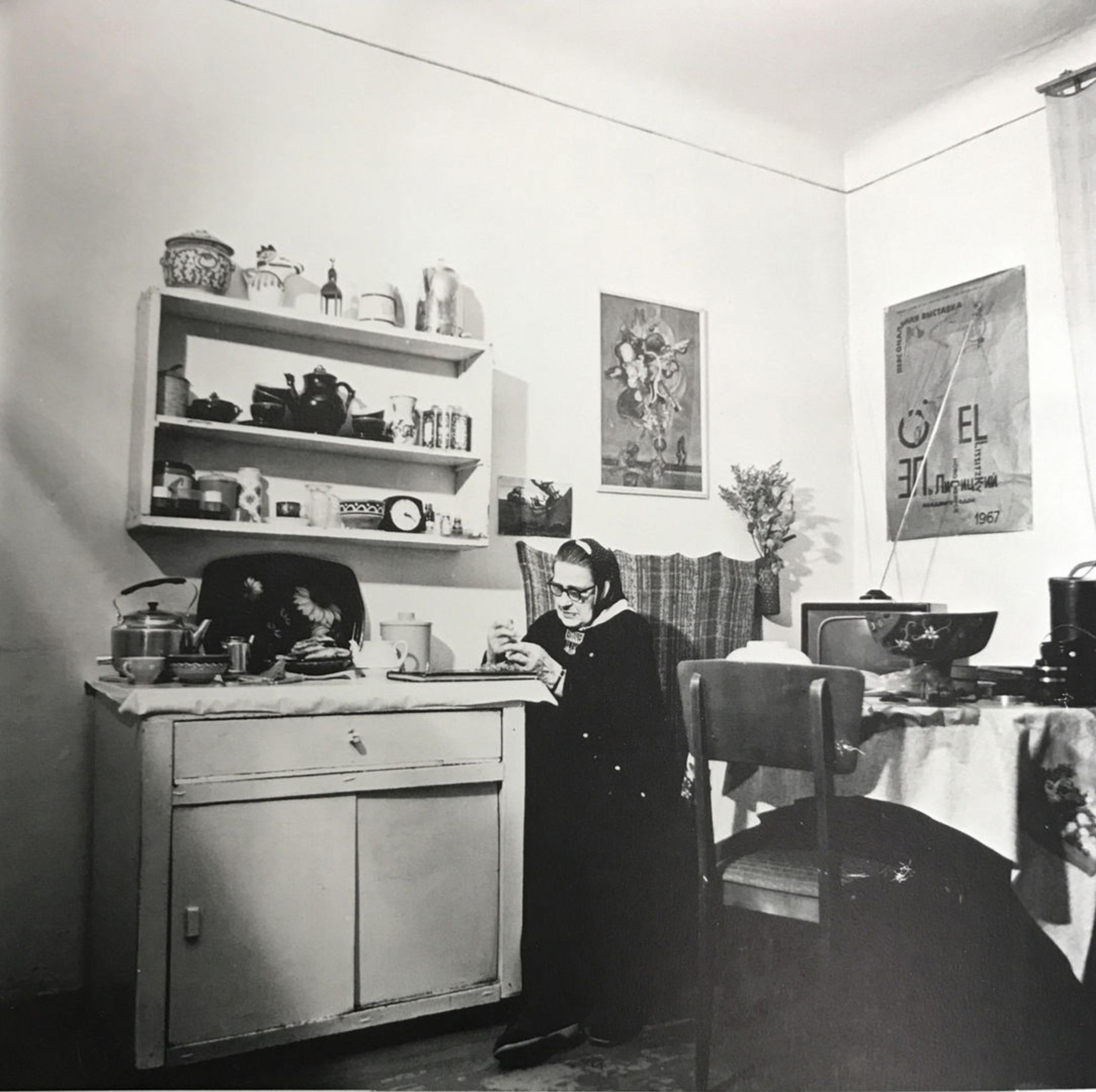 Black and white photo of Sophie as an older woman sitting in a simple kitchen