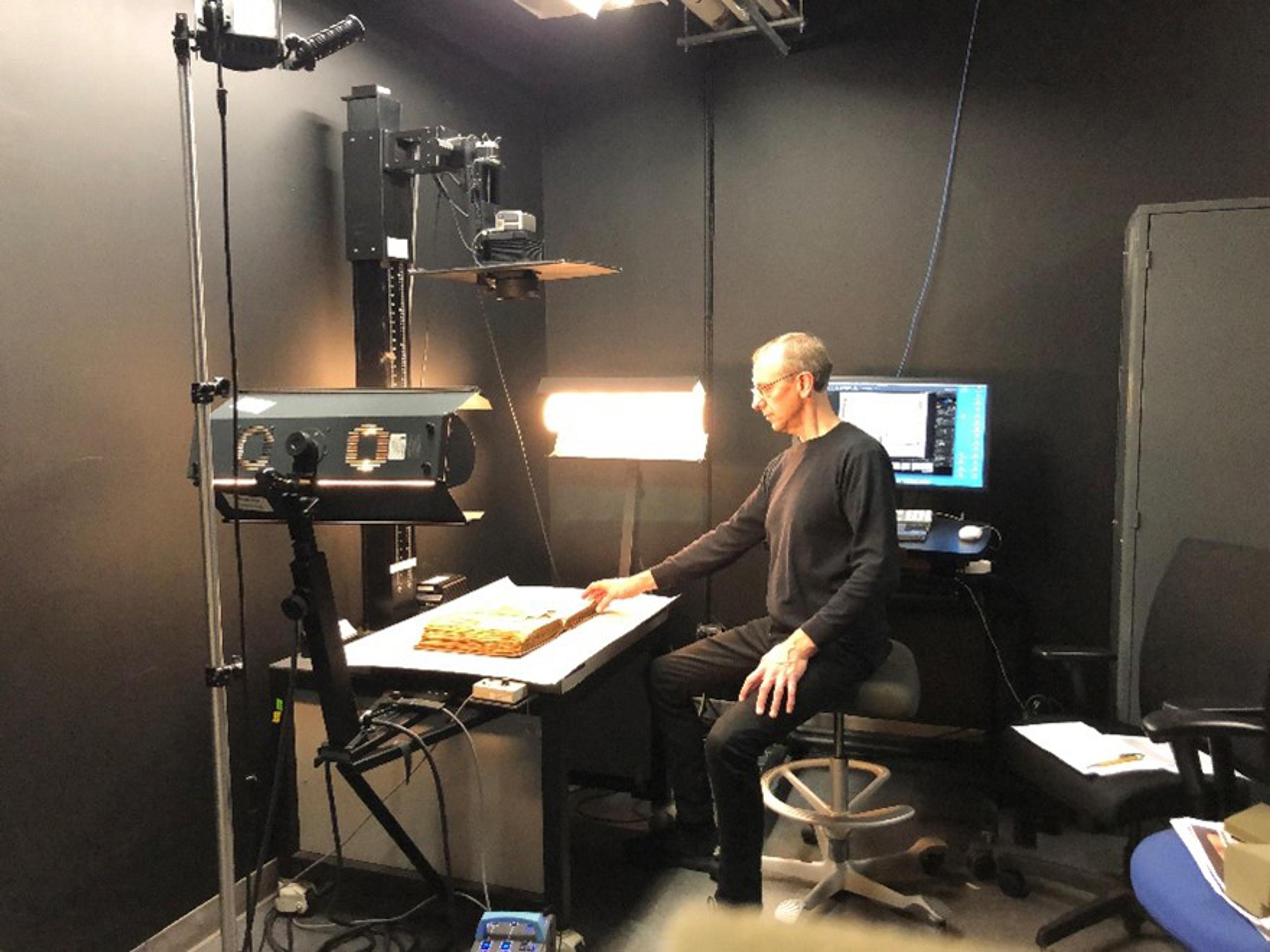 Jim Moske taking images of a scrapbook