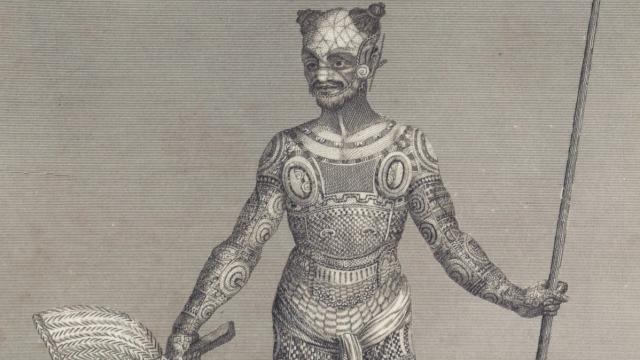 Engraving of a heavily tattooed man holding a spear and shield. His expression is neutral, and intricate patterns cover his body, conveying artistry.