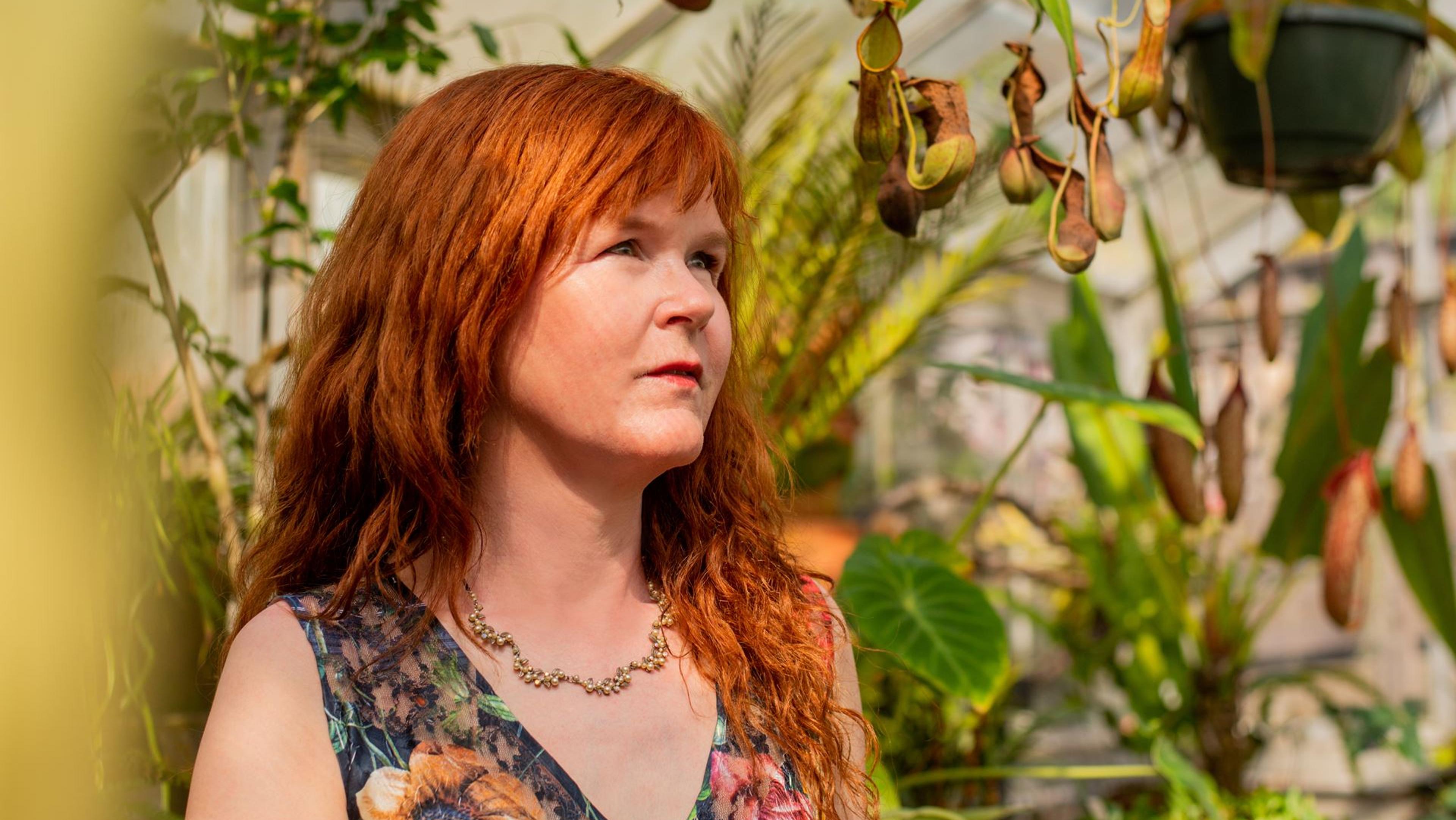 Sarah Cahill amongst a variety of plants.