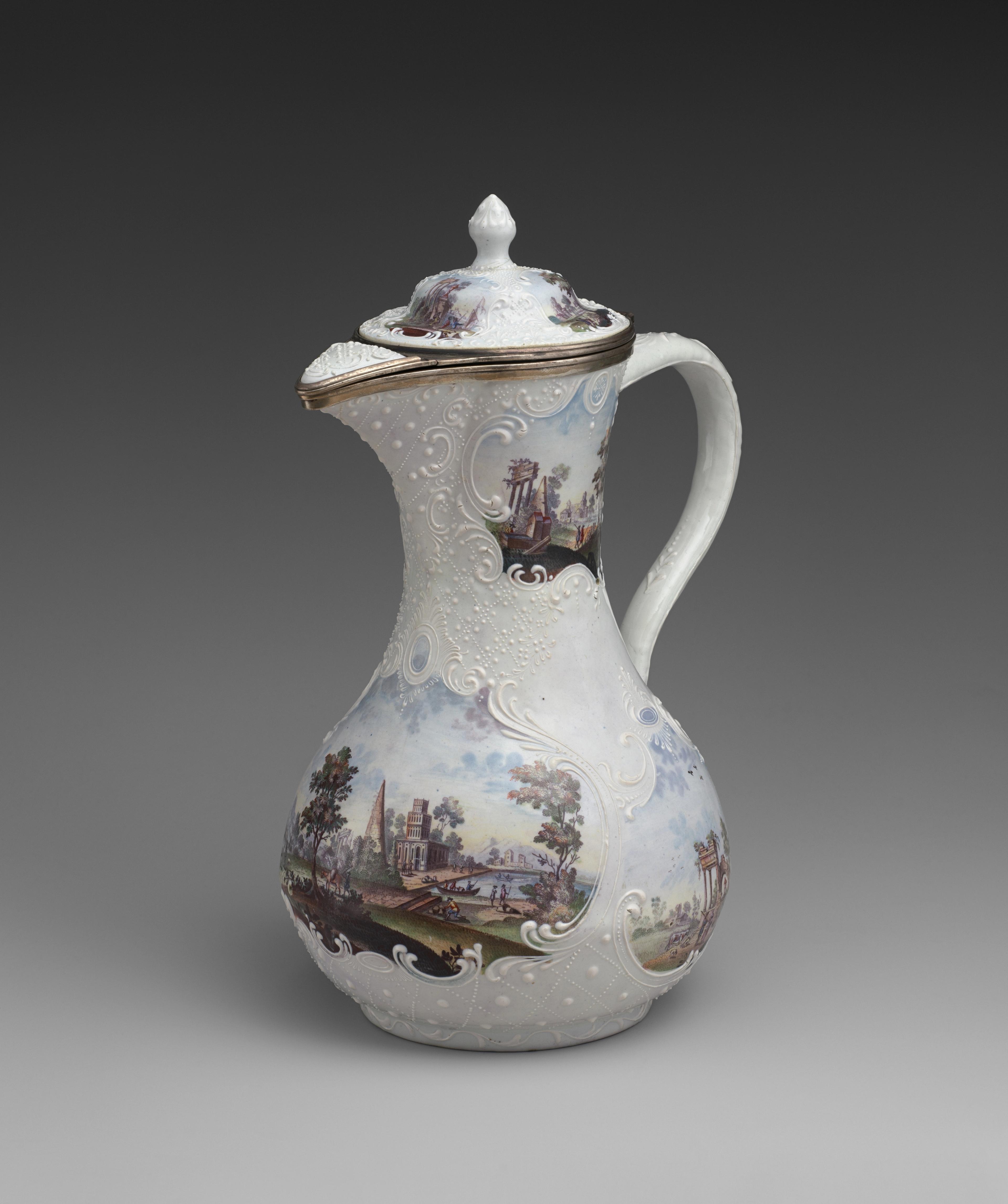 White pitcher decorated with pastoral scenes.