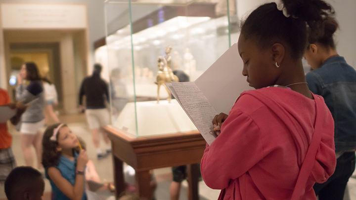 A girl taking notes for her story