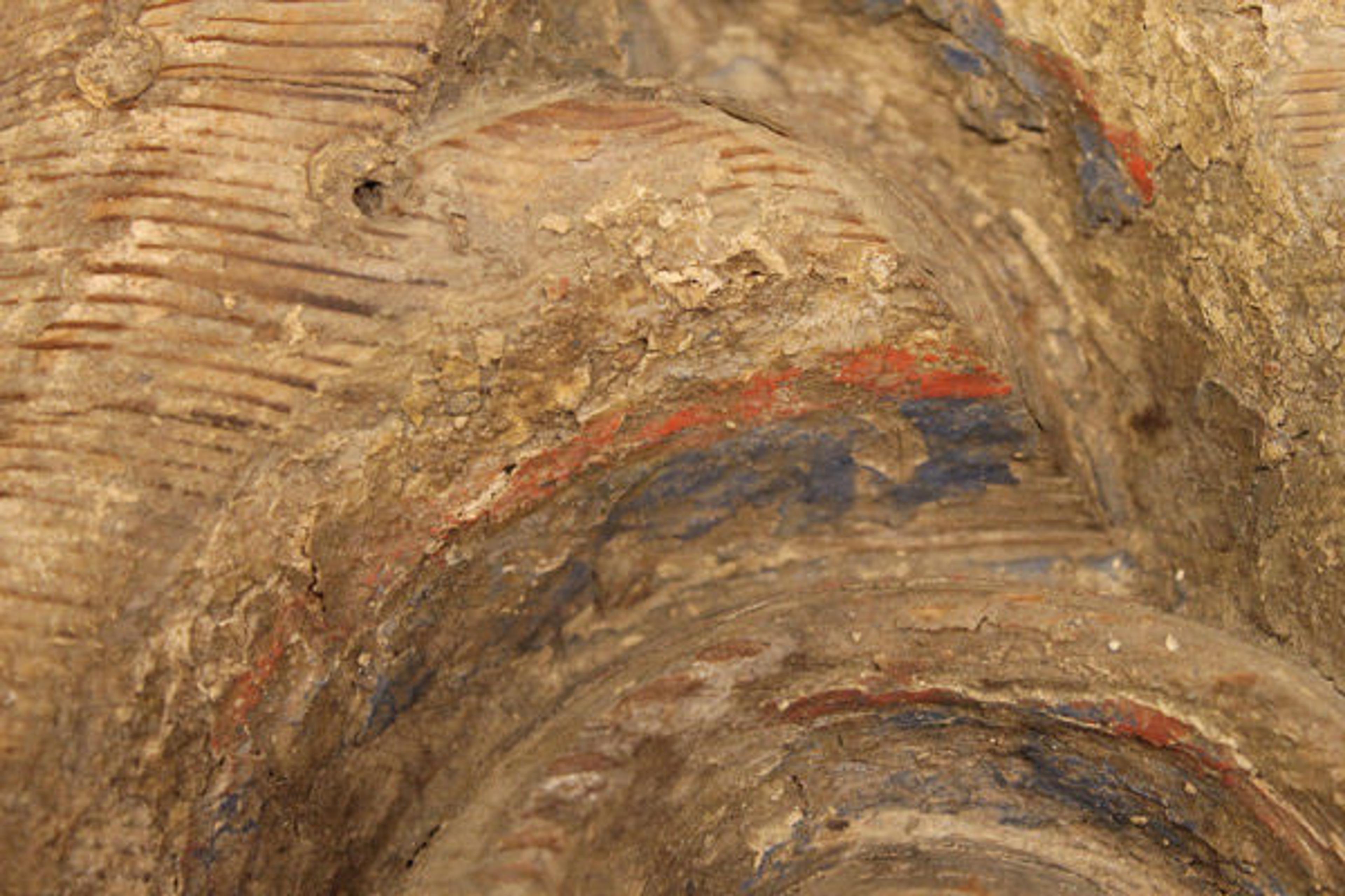 Detail of 32.102.1,2 showing traces of blue and red paint clinging to the surface