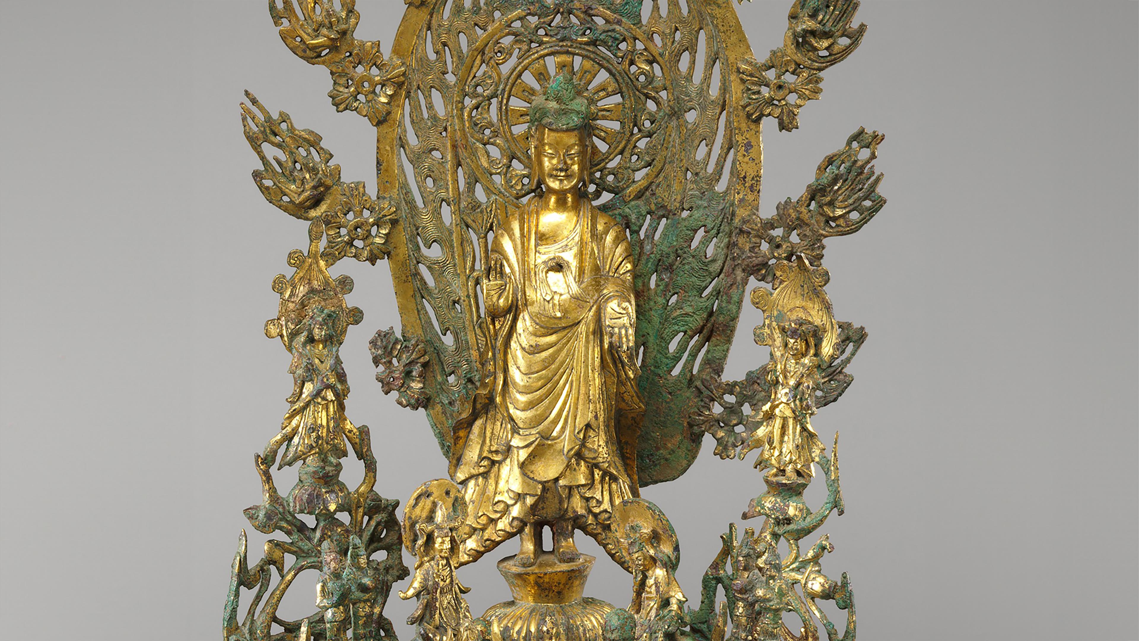 A bronze sculpture of the Buddha Maitreya surrounded by celestial musicians and a flaming halo as he descends to earth to rescue the devout.