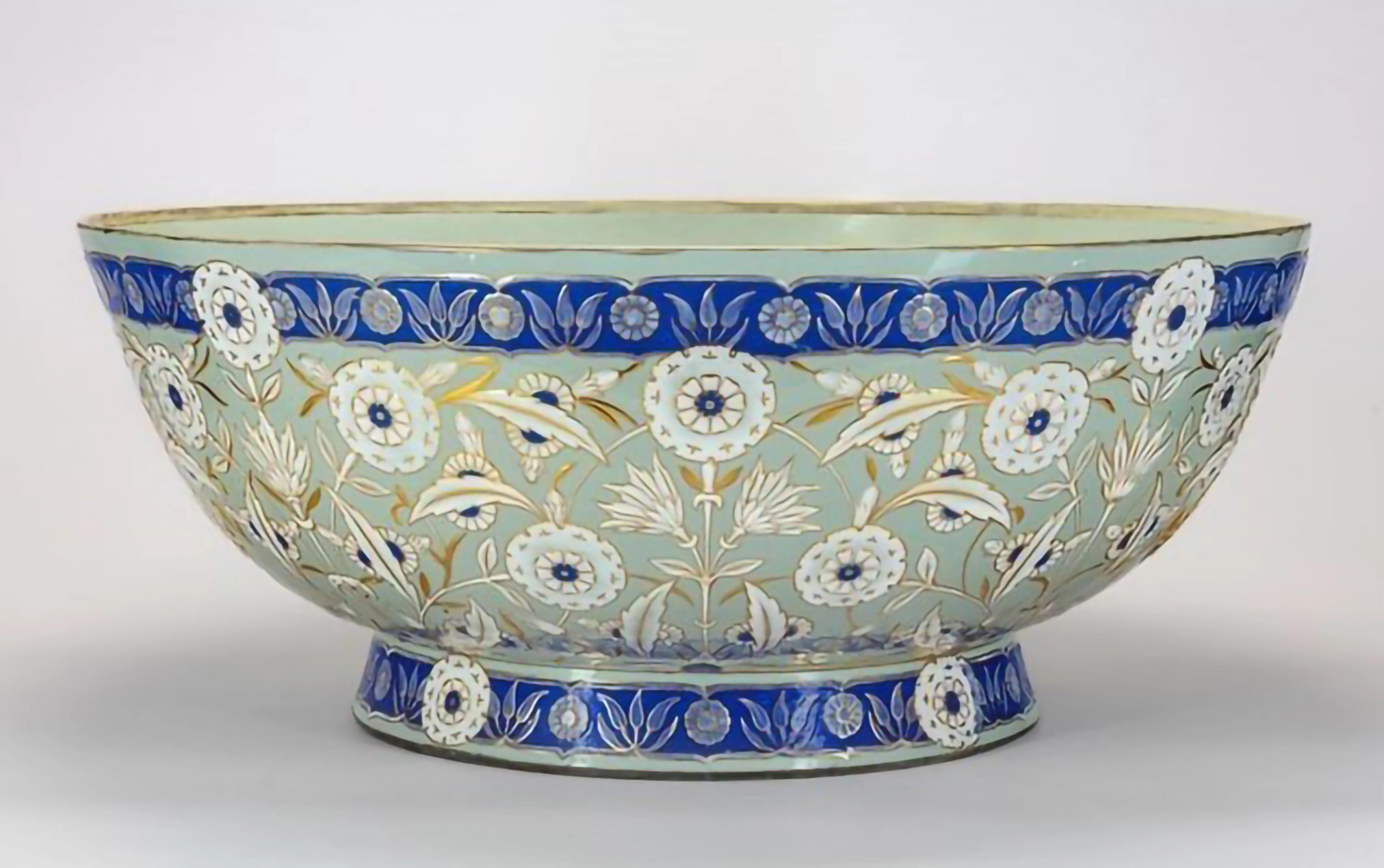 Green, blue, and white ceramic bowl with floral motifs