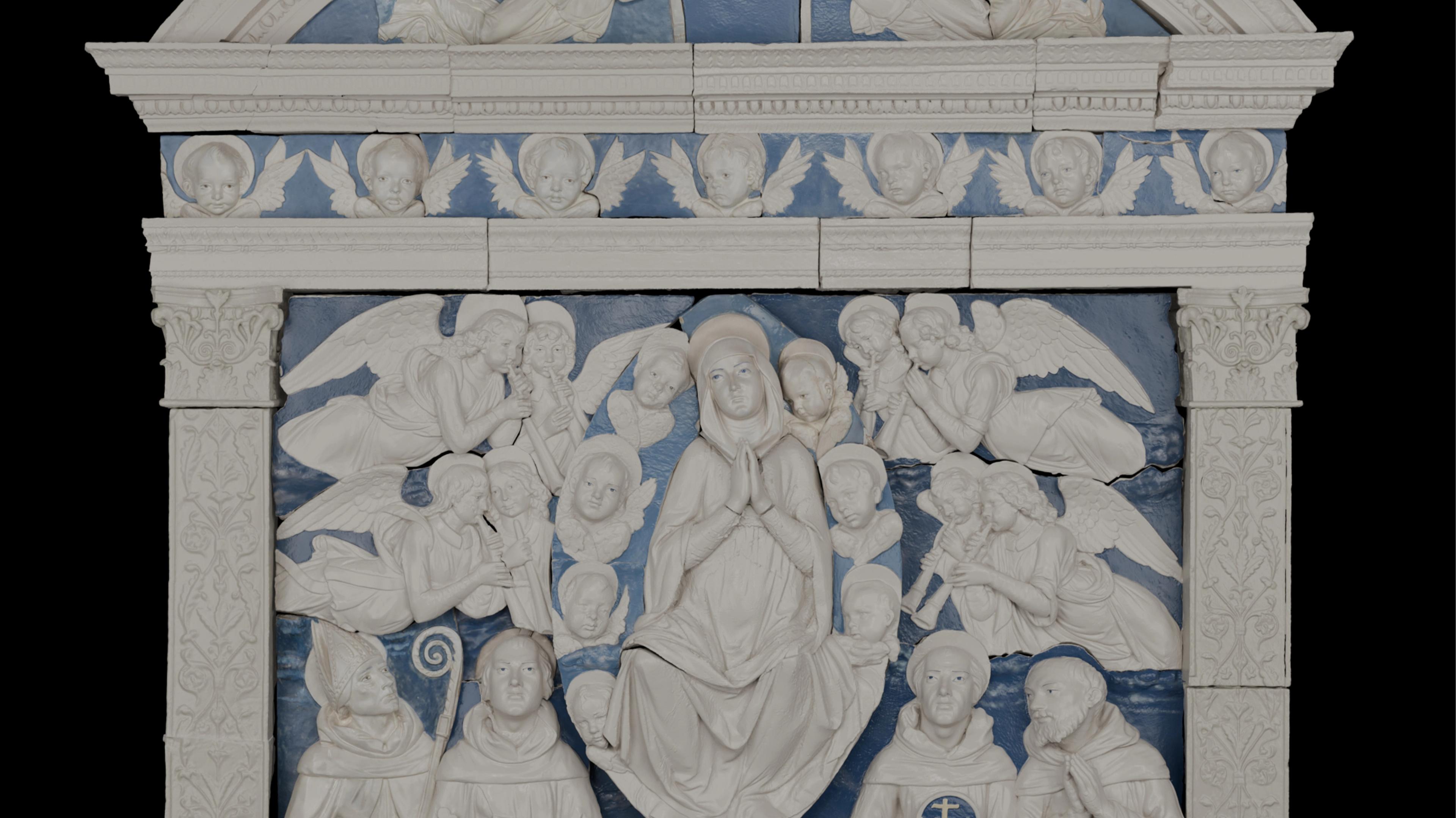 Religious relief sculpture featuring a central figure surrounded by angels, set against a blue background. 