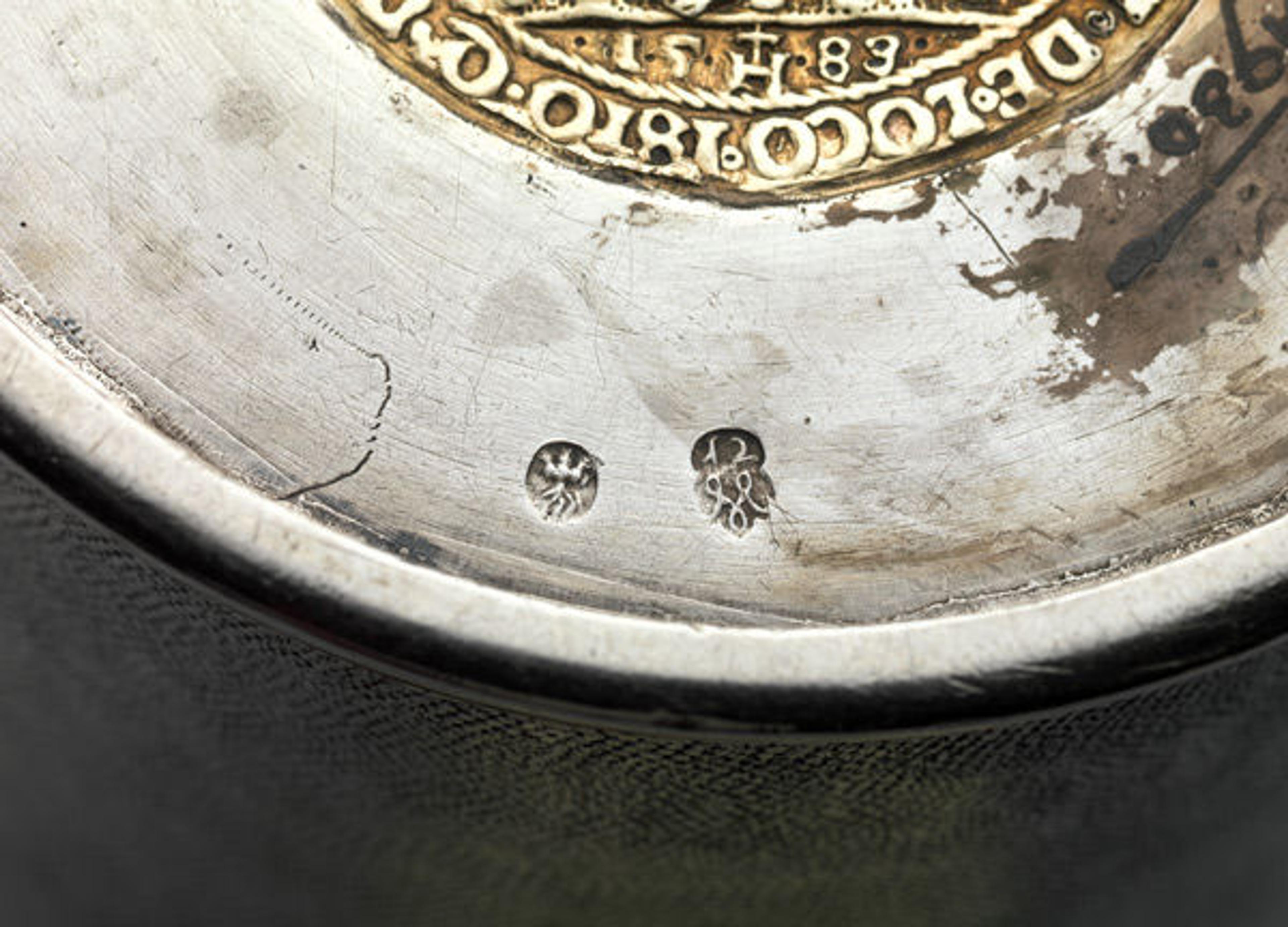 On the underside of this beaker, the town mark of Brassó (in present-day Romania) can be seen on the left, and the maker's mark of Michael May II on the right. Michael May II (active 1731–76). Beaker, ca. 1740. Hungarian, Brassó. Silver, partly gilded; Overall: 6 x 4 1/4 in. (15.3 x 10.8 cm). The Metropolitan Museum of Art, New York, Gift of The Salgo Trust for Education, New York, in memory of Nicolas M. Salgo, 2010 (2010.110.54)