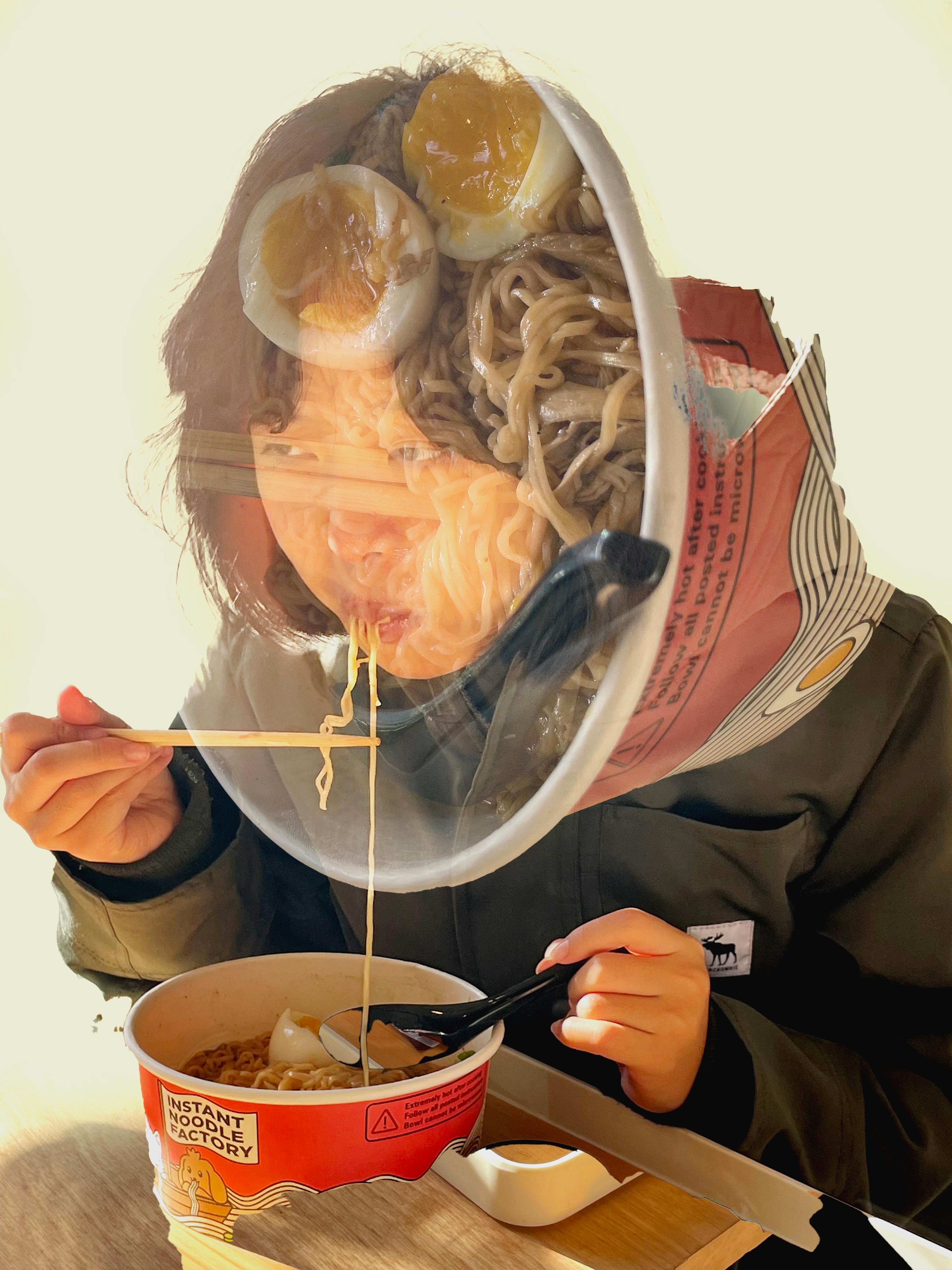 Digital-media photograph of a dark-haired adolescent Asian girl seated at a wooden table, eating ramen noodles from a large, red paper container, using chopsticks in her right hand and holding a black soup spoon in her left hand. The girl leans over the table, facing left, and wears a heavy gray coat. A long noodle runs from her lips to the container below, partially held by the chopsticks. Supermiposed on the girl's face is a sideways translucent photo of the open top of the red container, showing noodles, two halves of a boiled egg, and the black soup spoon dug into the noodles.