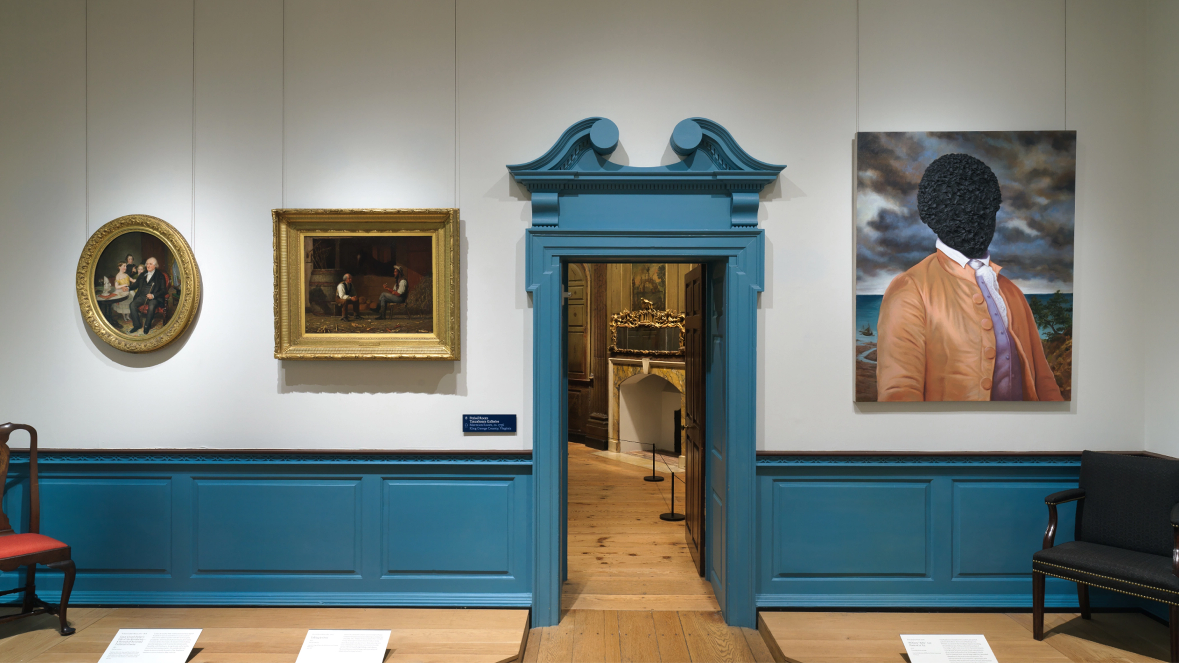 Gallery view of the American Wing, featuring paintings and a striking blue doorway and paneling.