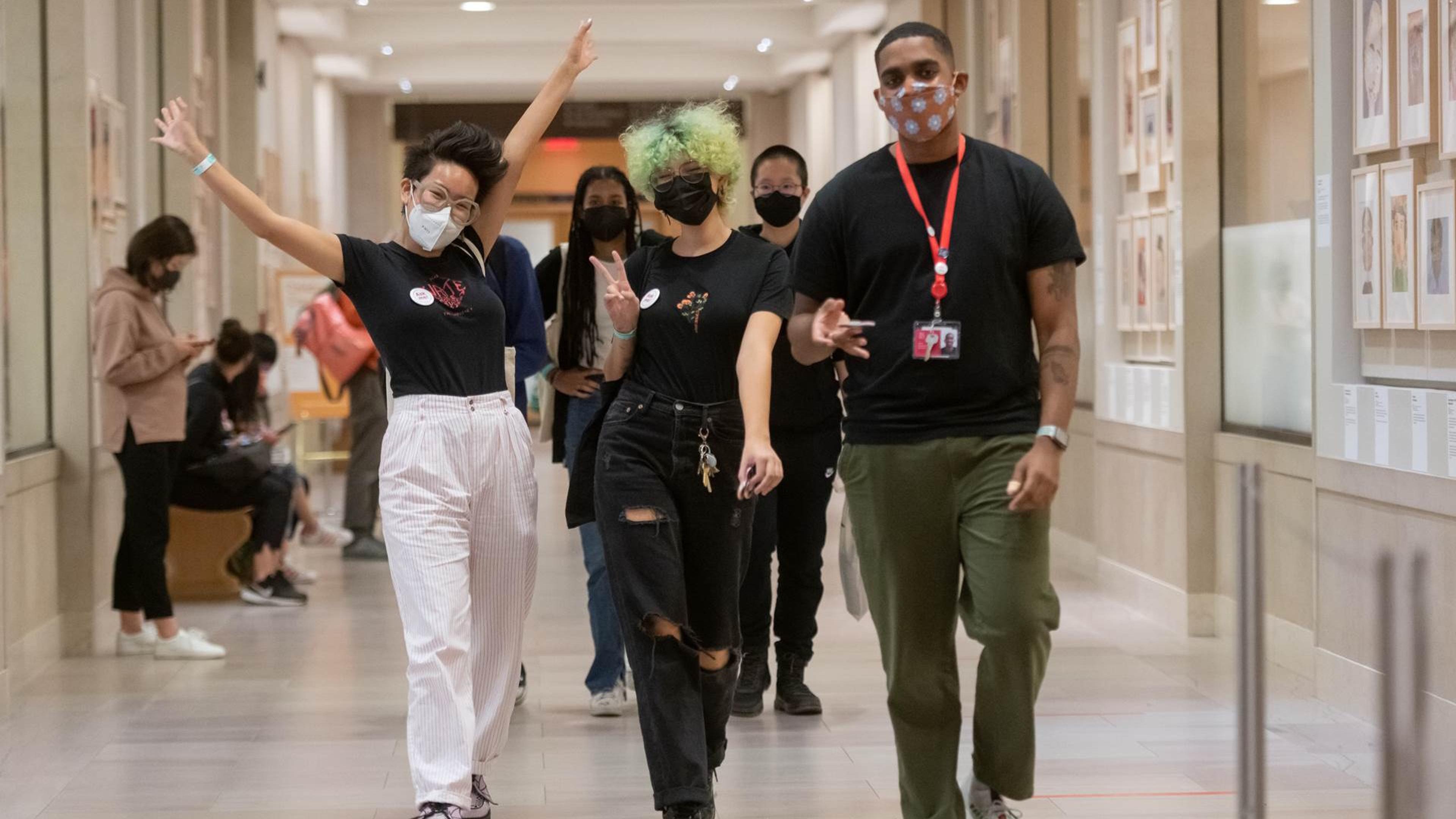 Three teens walking down a hallway in The Met's Ruth and Harold D. Uris Center for Education
