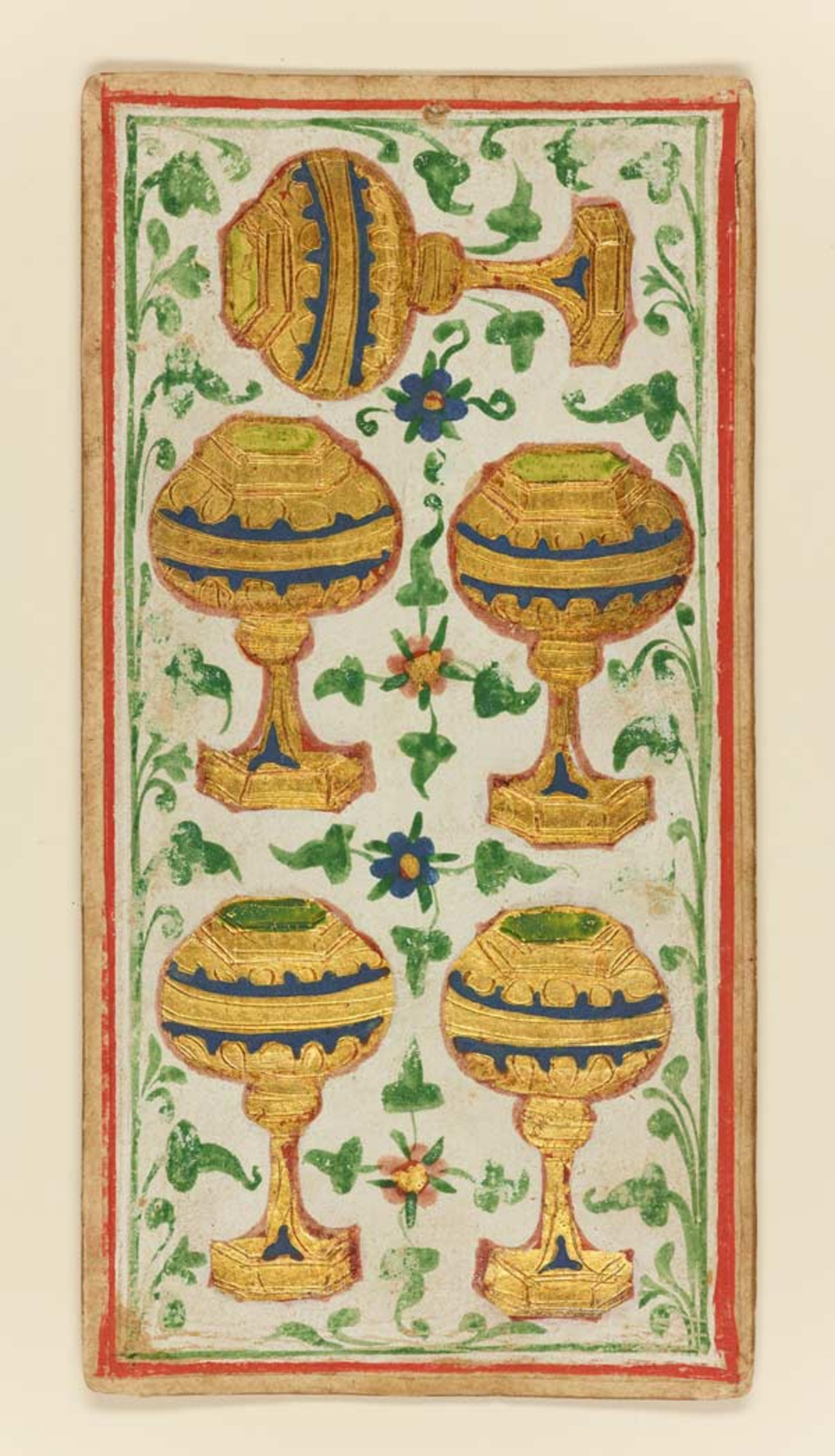 A tarot card showing 6 gold cups with a green leaf background.