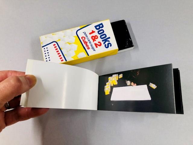 Hand turning the page of a small book