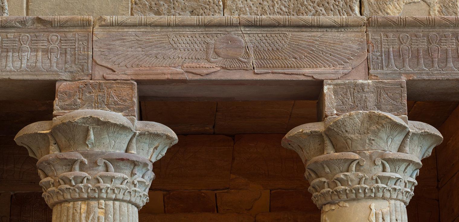 Capitals of the south and north columns with a winged sun disk above.