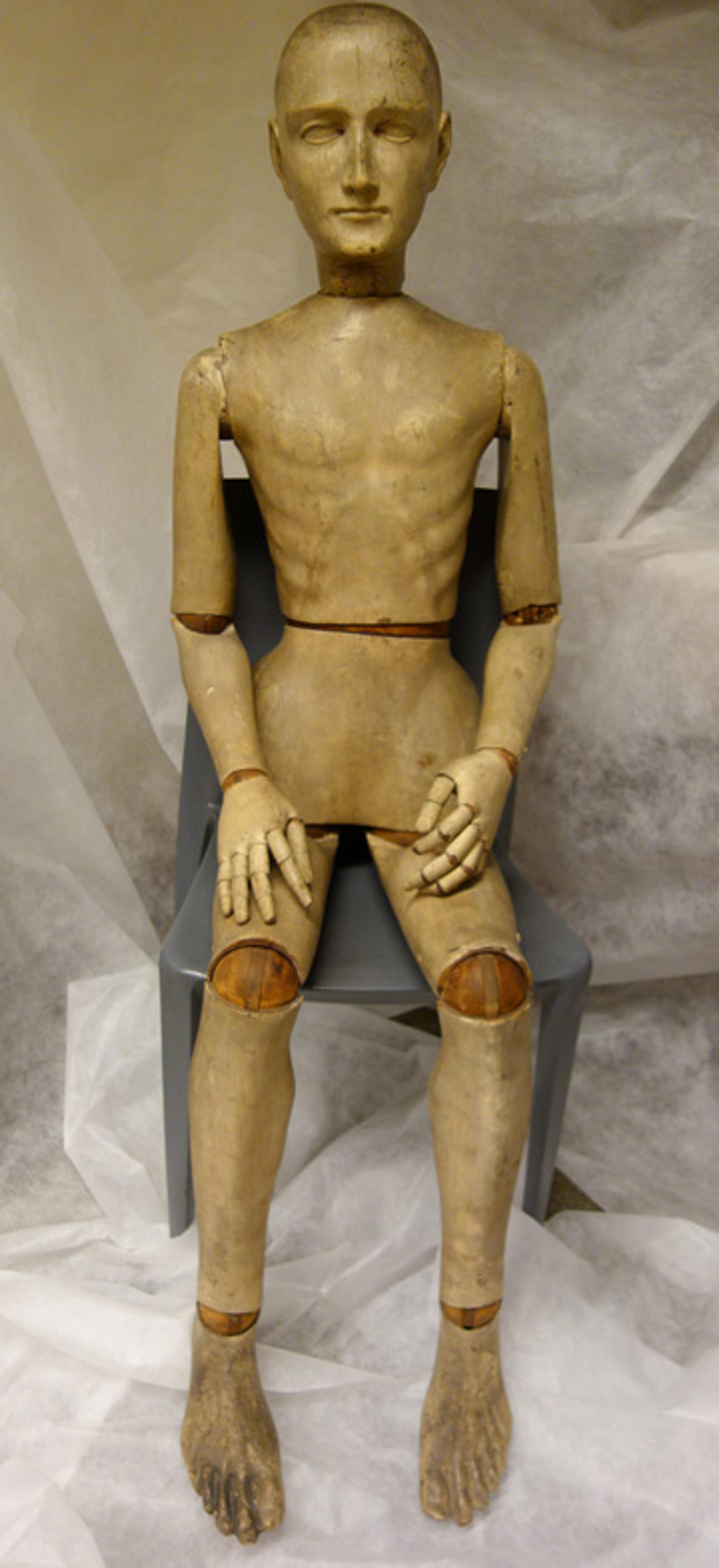 A full-body view of a 19th-century French mannequin made of wood