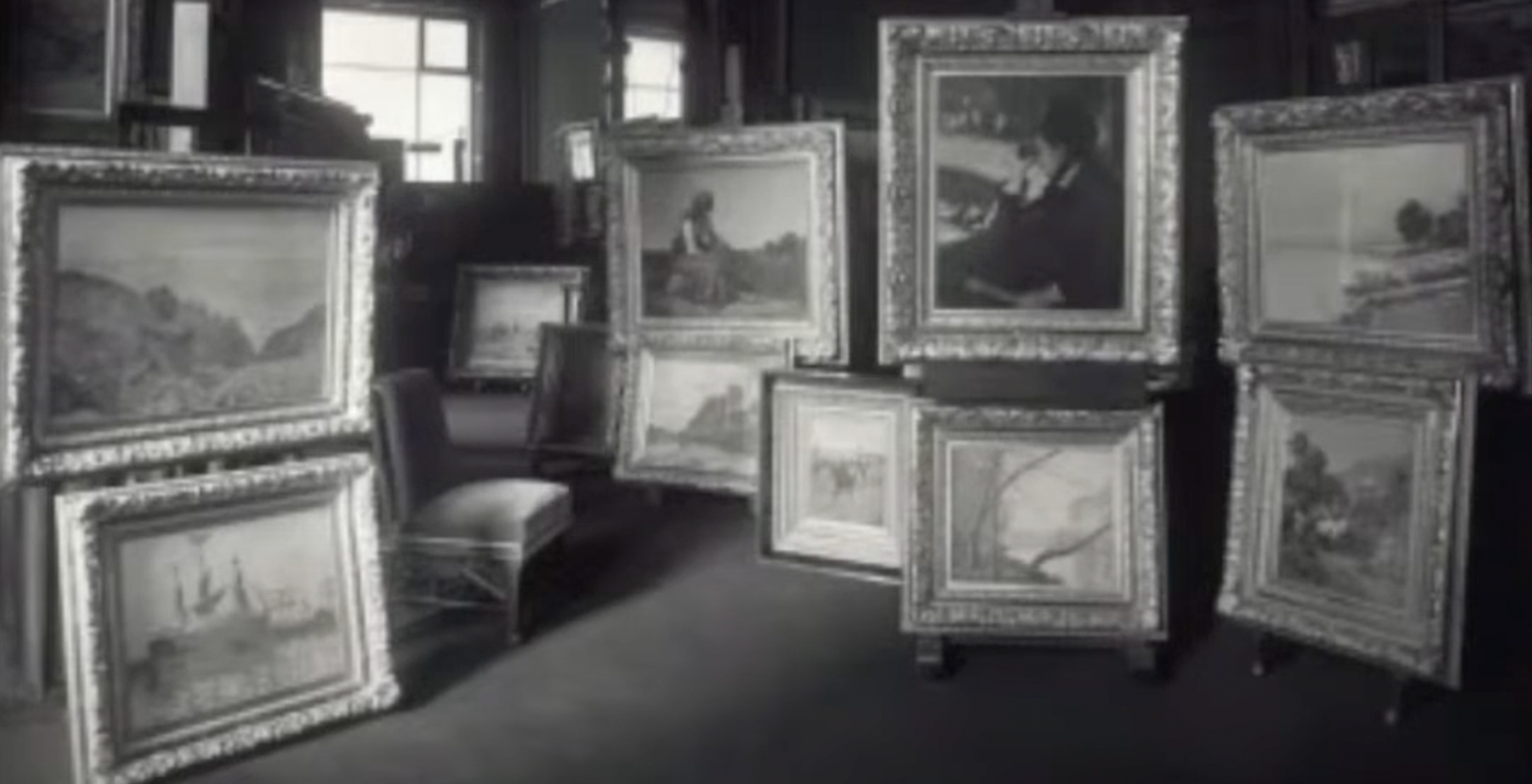 Black and white interior of the Durand-Ruel Gallery with many Impressionist paintings.