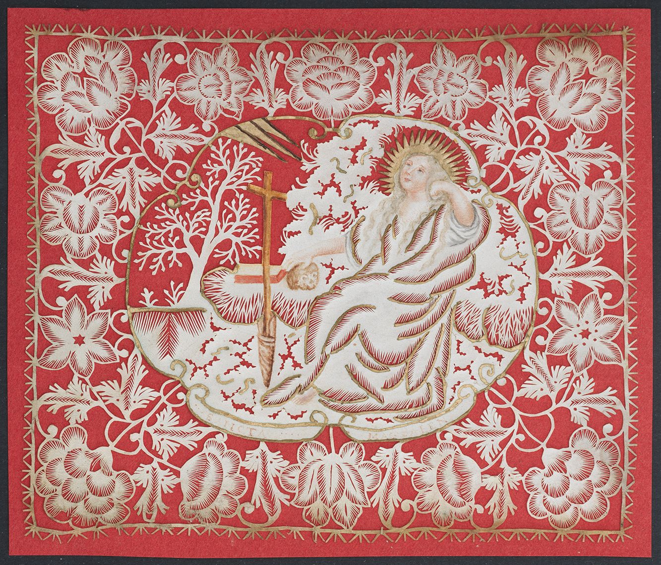 Cut paper devotional of a reclining Mary Magdalene with floral border mounted on red paper.