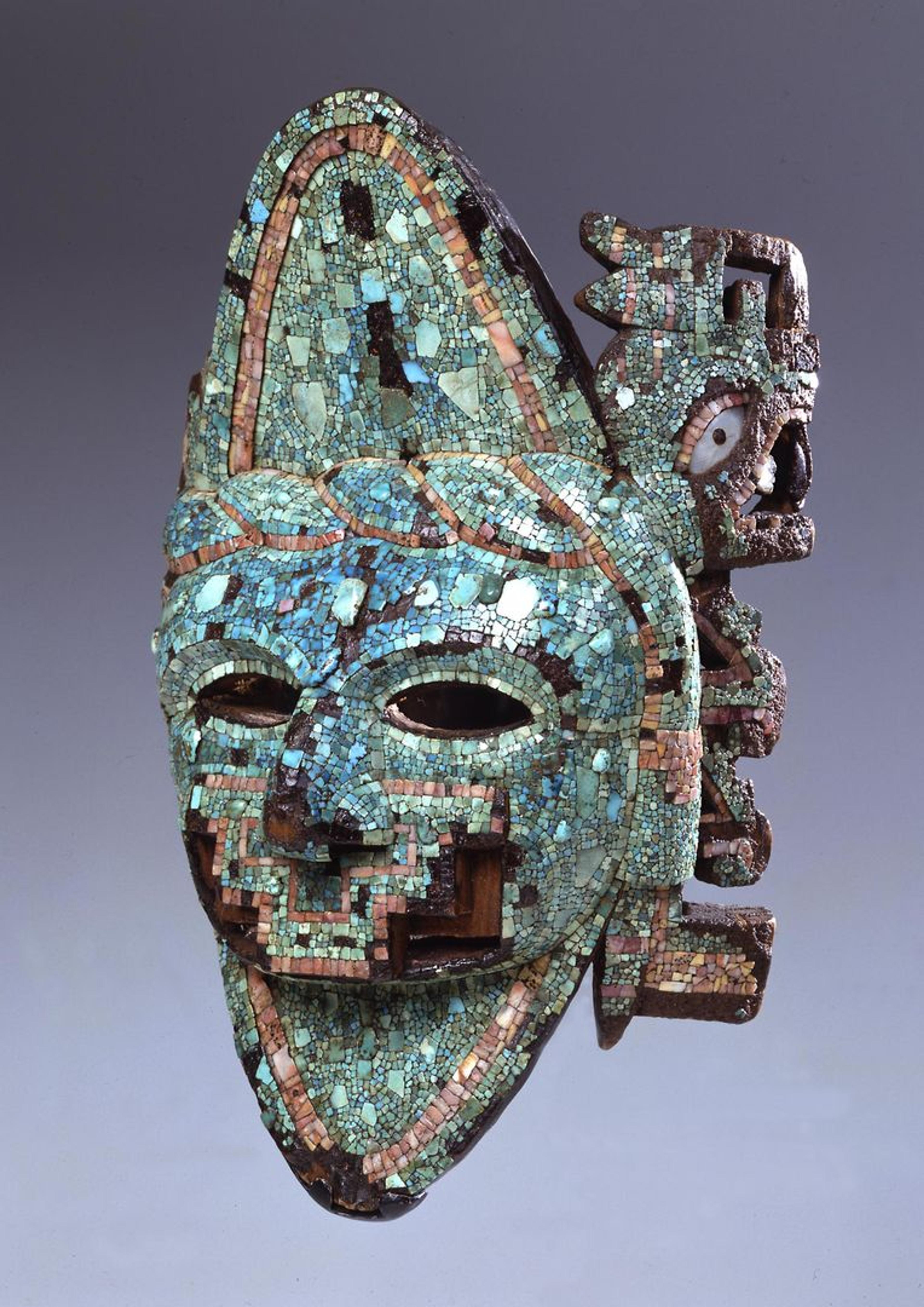 A mask from the ancient Americas made of turquoise, wood, mother-of-pearl, shell 