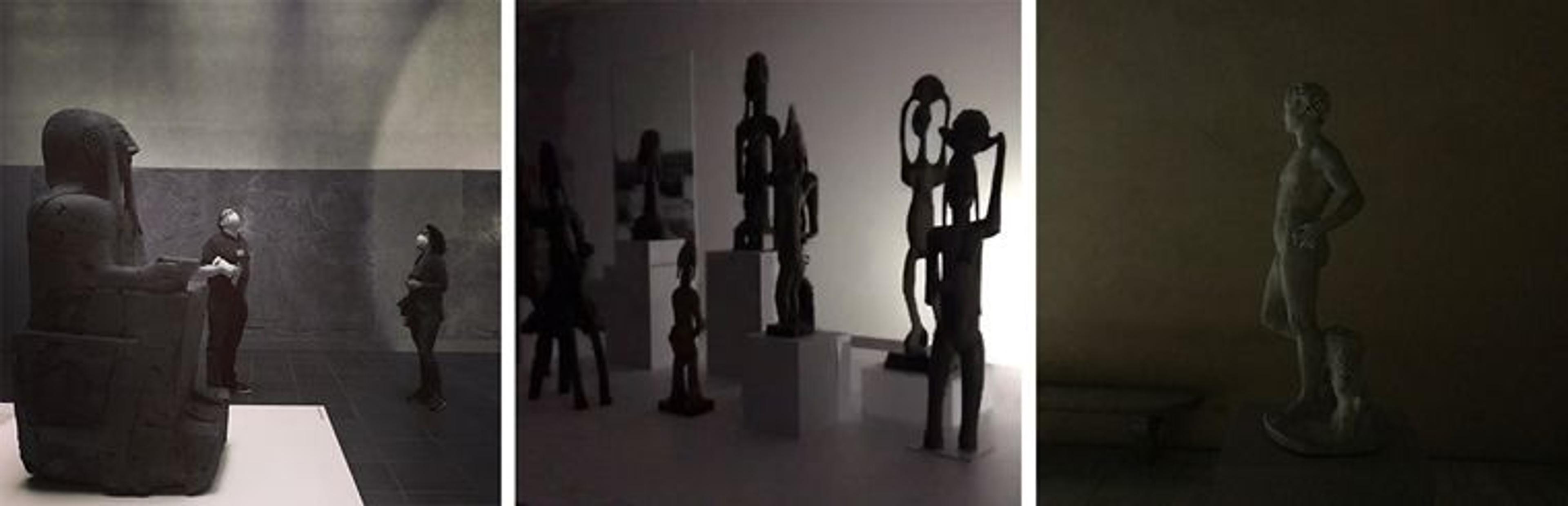 Left: two people stand in a dark gallery with a large statue of a seated figure to their left. Center: tall, thin statues arranged in a tableau cast shadows as they are hit by a flashlight beam. Right: a statue of a standing man is cast in darkness.