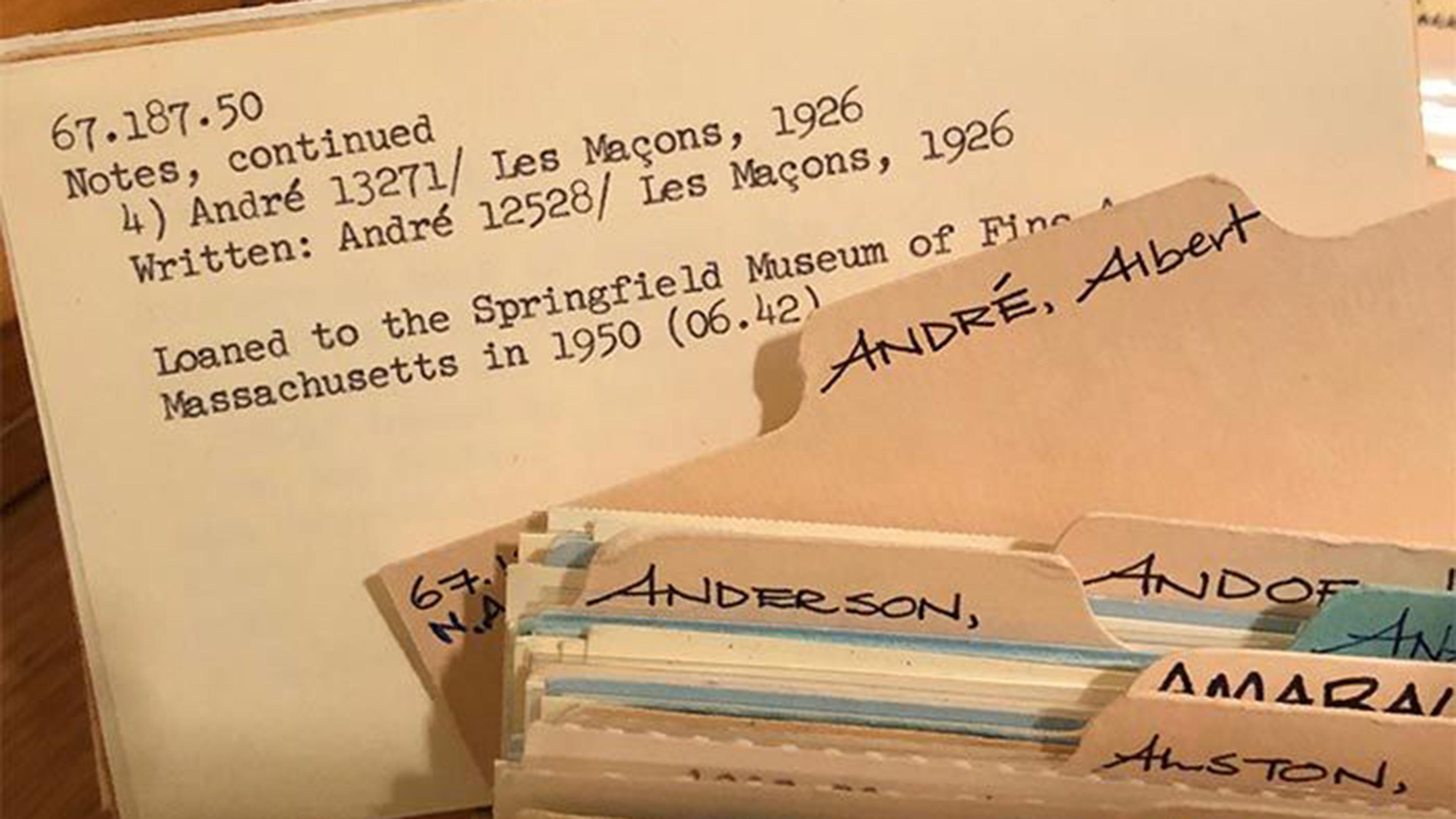 Typed catalogue notecard with details about a 1926 loan the Springfield Museum shown with a selection of file folders.