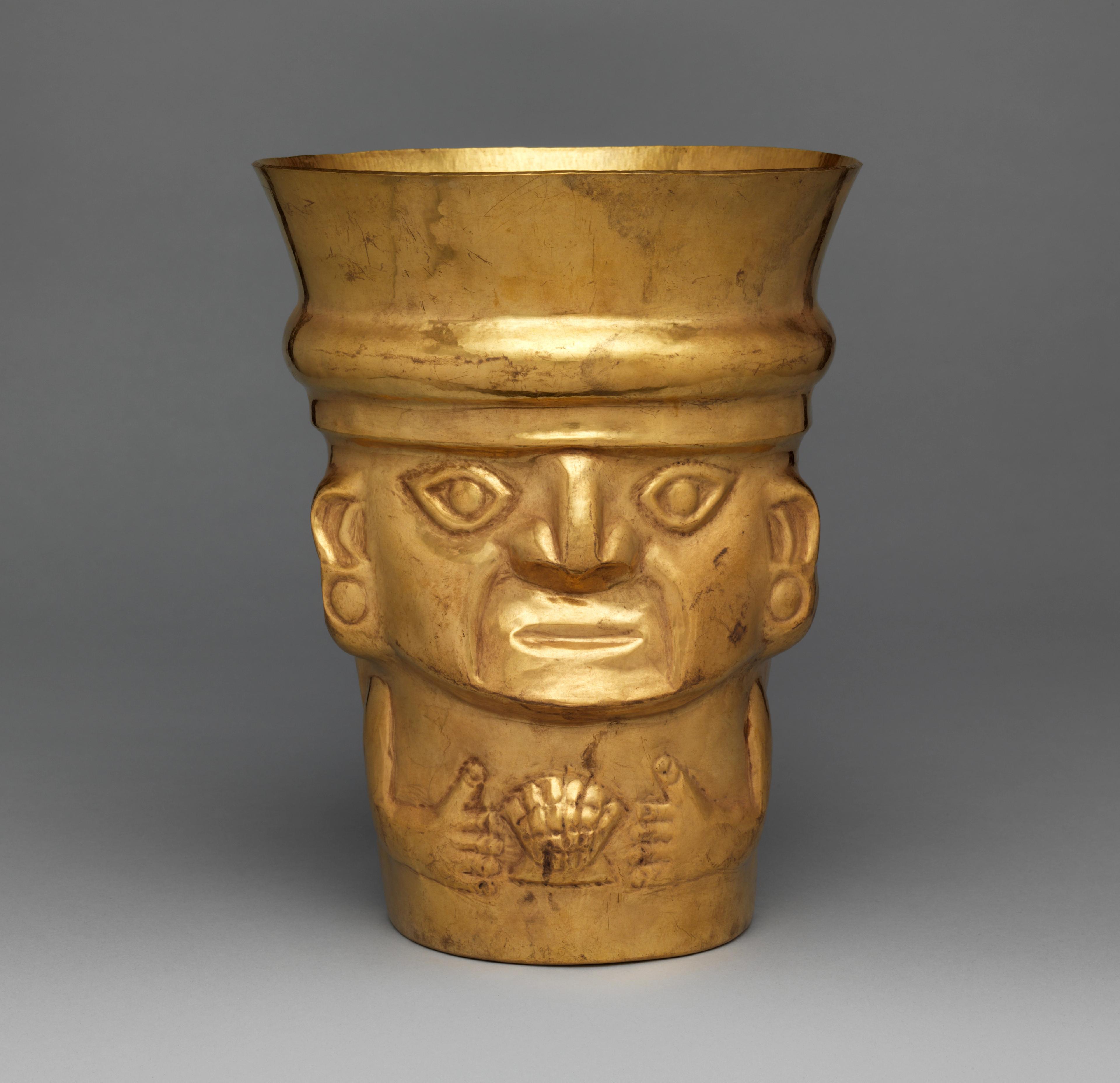 Gold drinking vessel showing a figure holding a shell