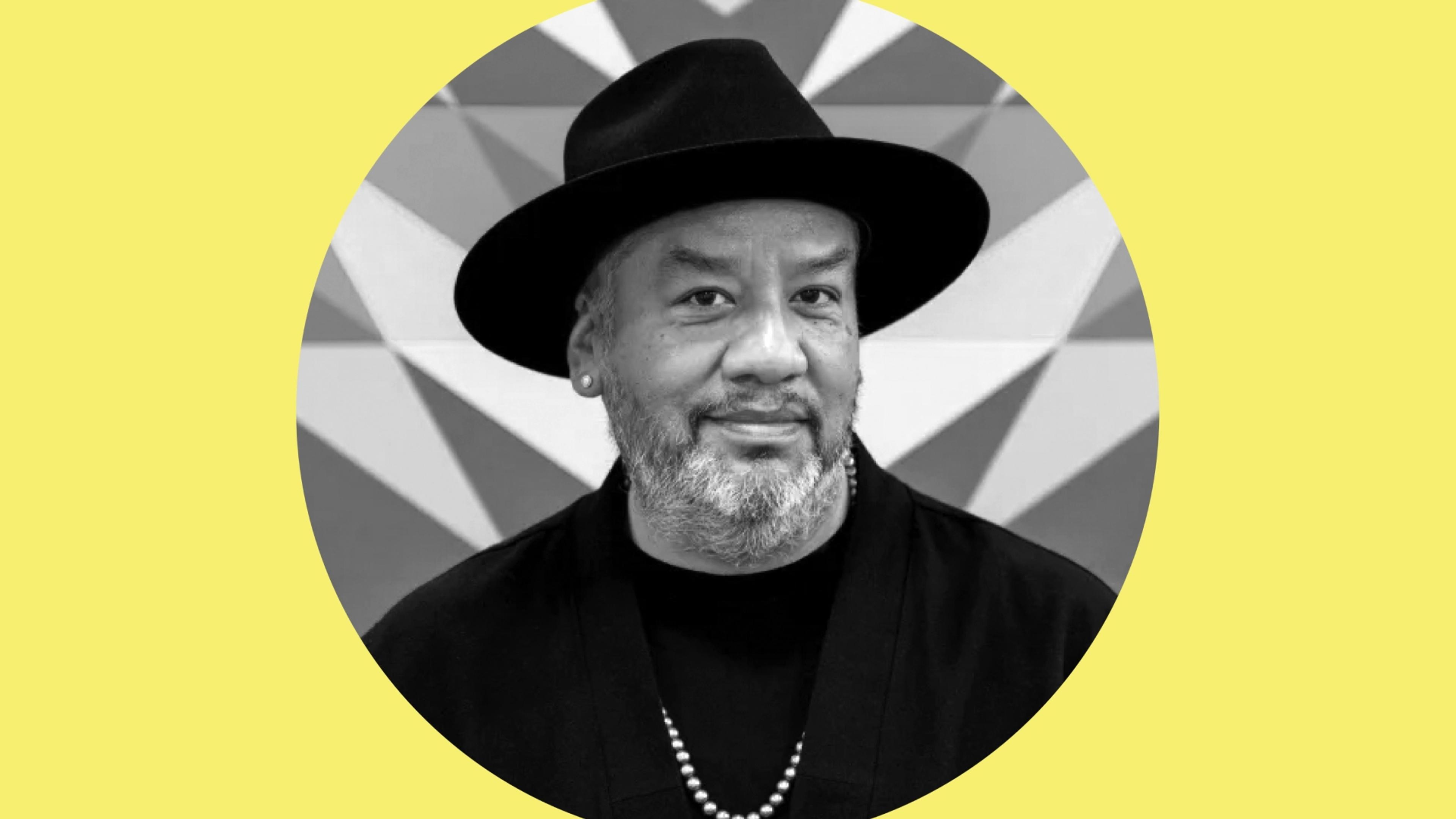 Black-and-white headshot of Jeffrey Gibson in a circular frame against a yellow background.