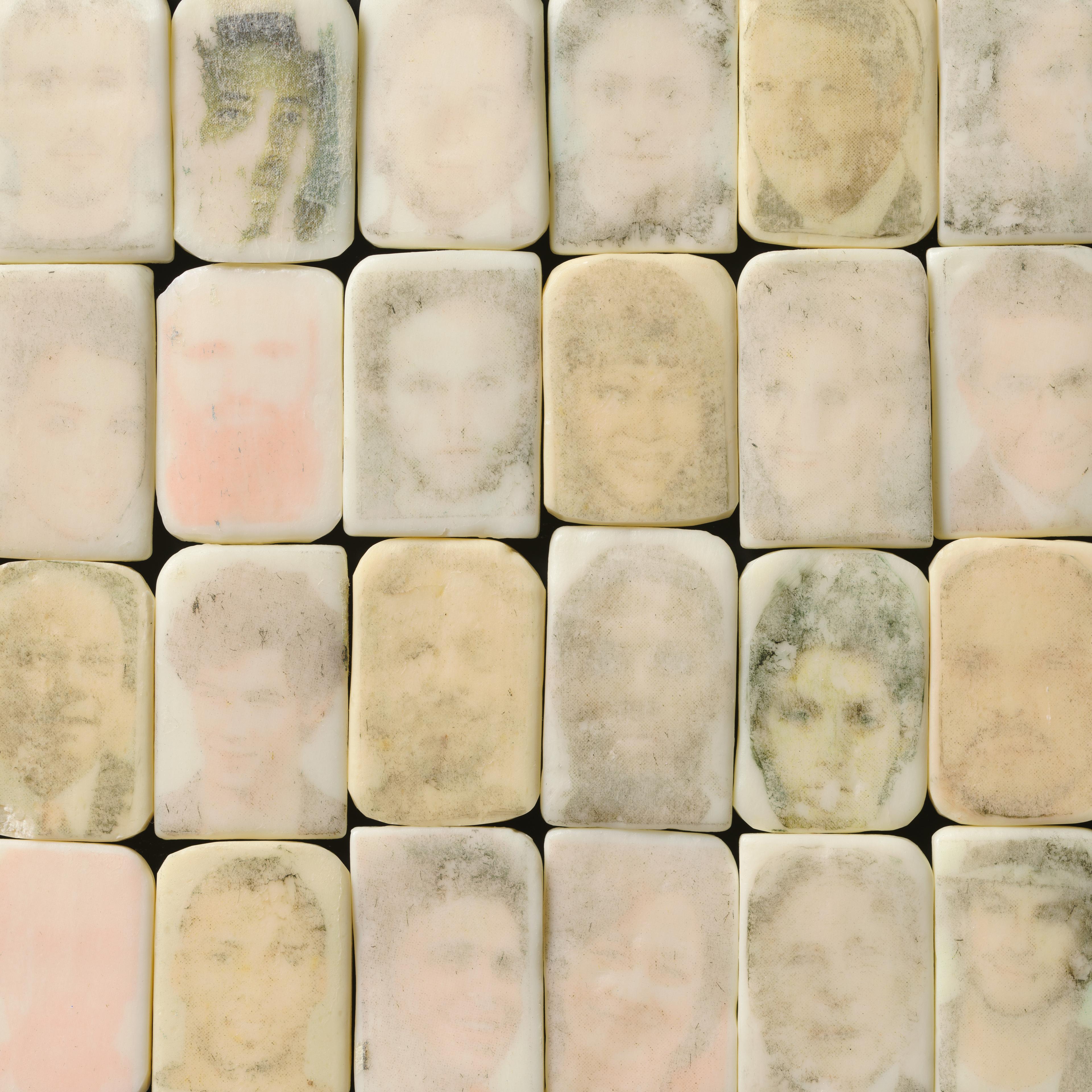 Marble stones aligned with faces drawn on them. 