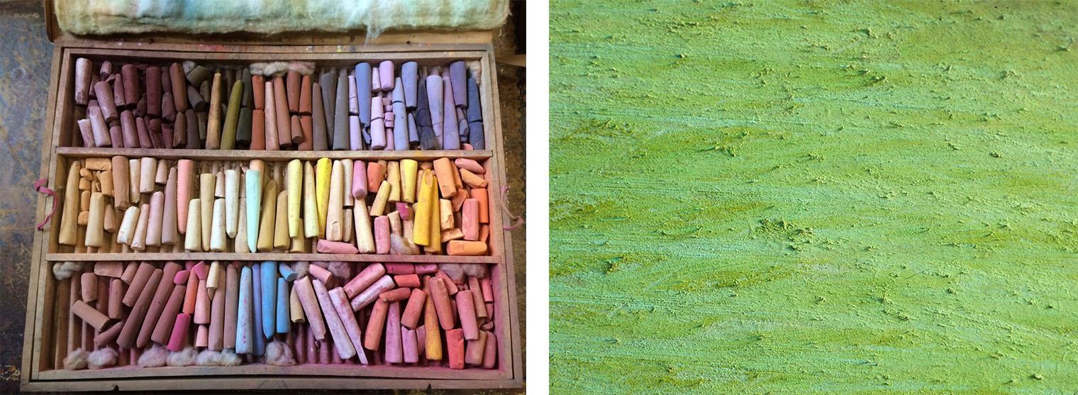 At left, a box with three rows of multicolored pastels, and at right, an uneven, rough greenish surface