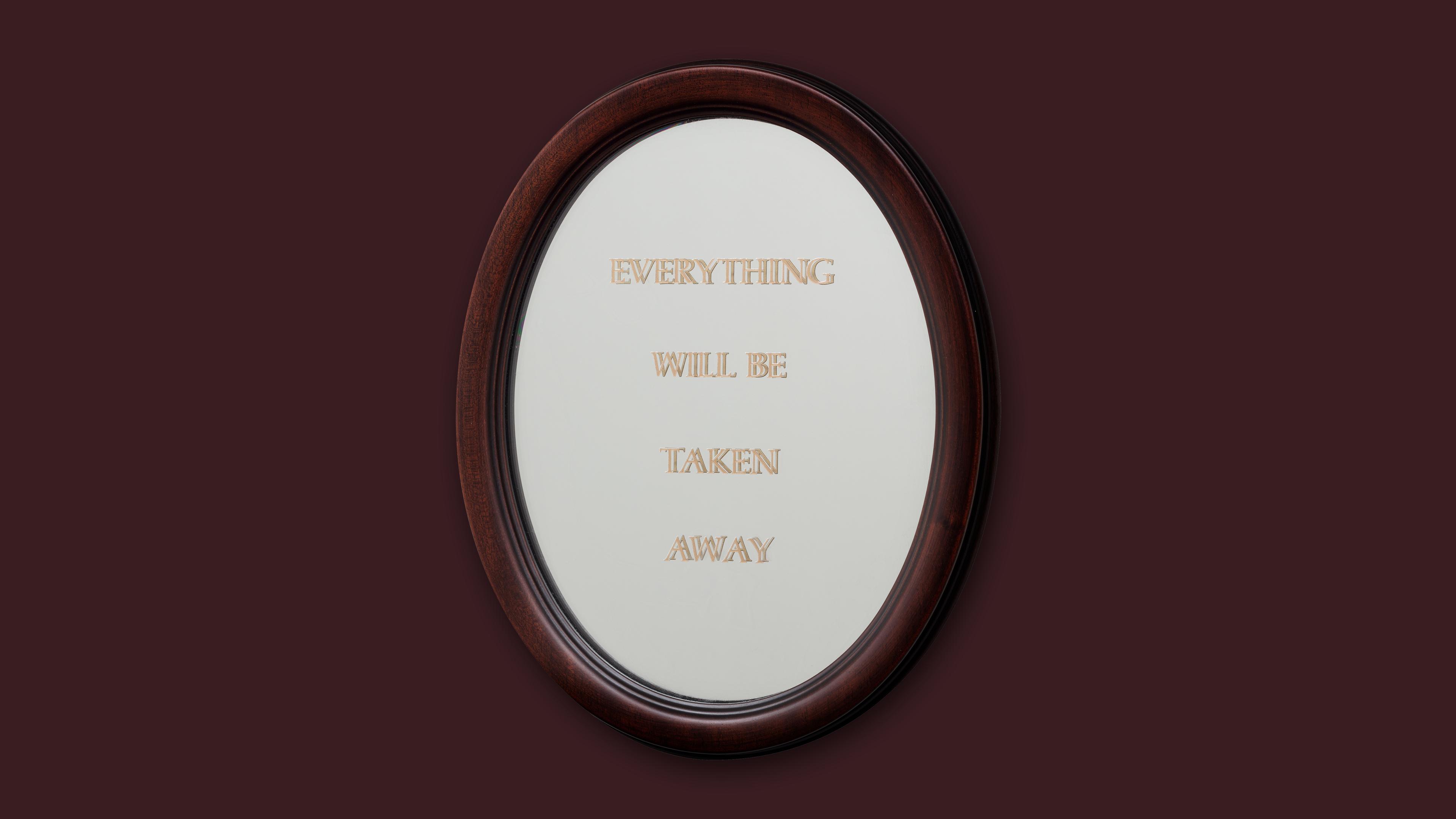 Brown backdrop with an oval mirror in the center that reads " Everything Will Be Taken Away" in capital letters. 