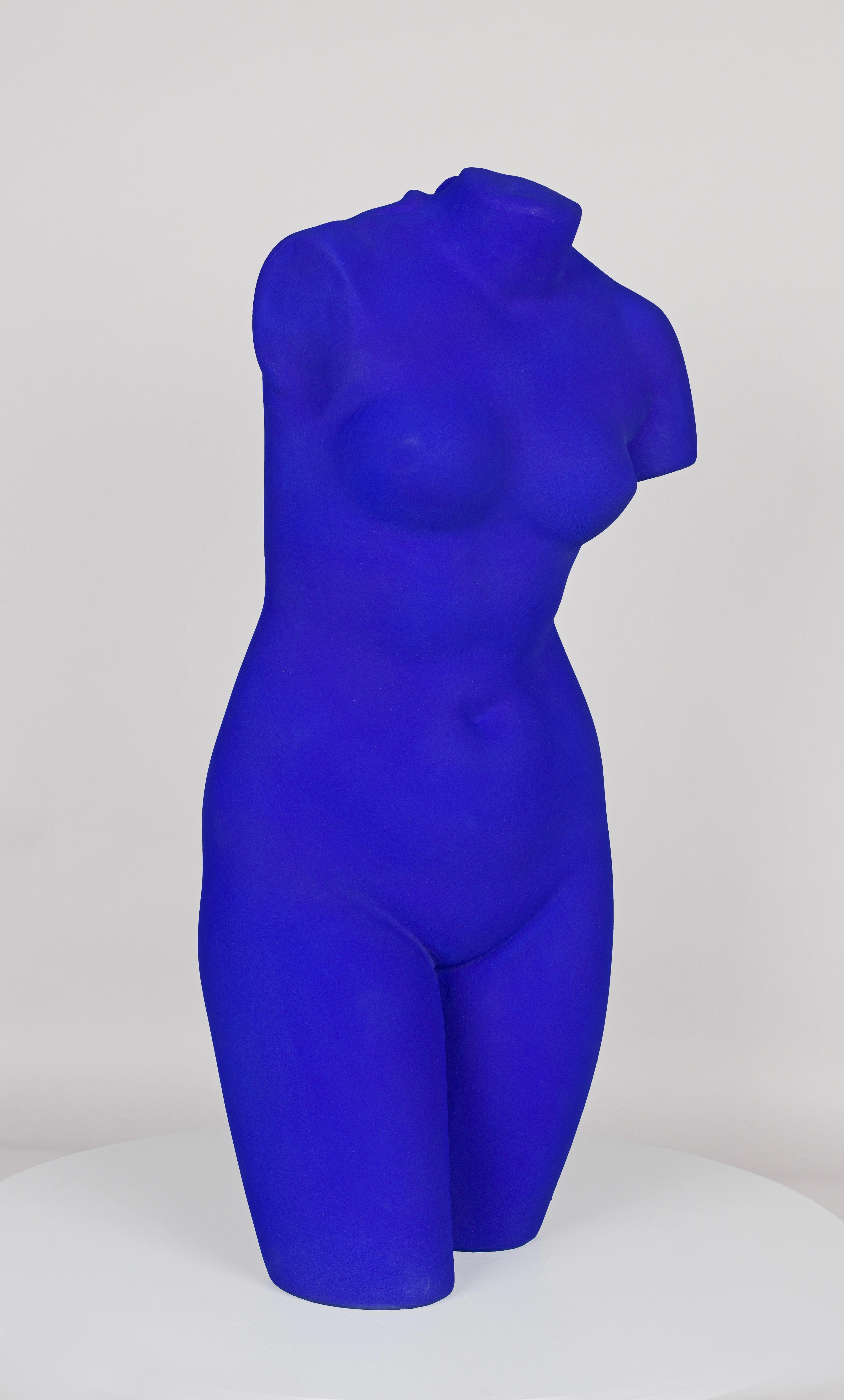Yves Klein statue of a female torso painted in bold IKB blue, without a head and cut off above the knees.