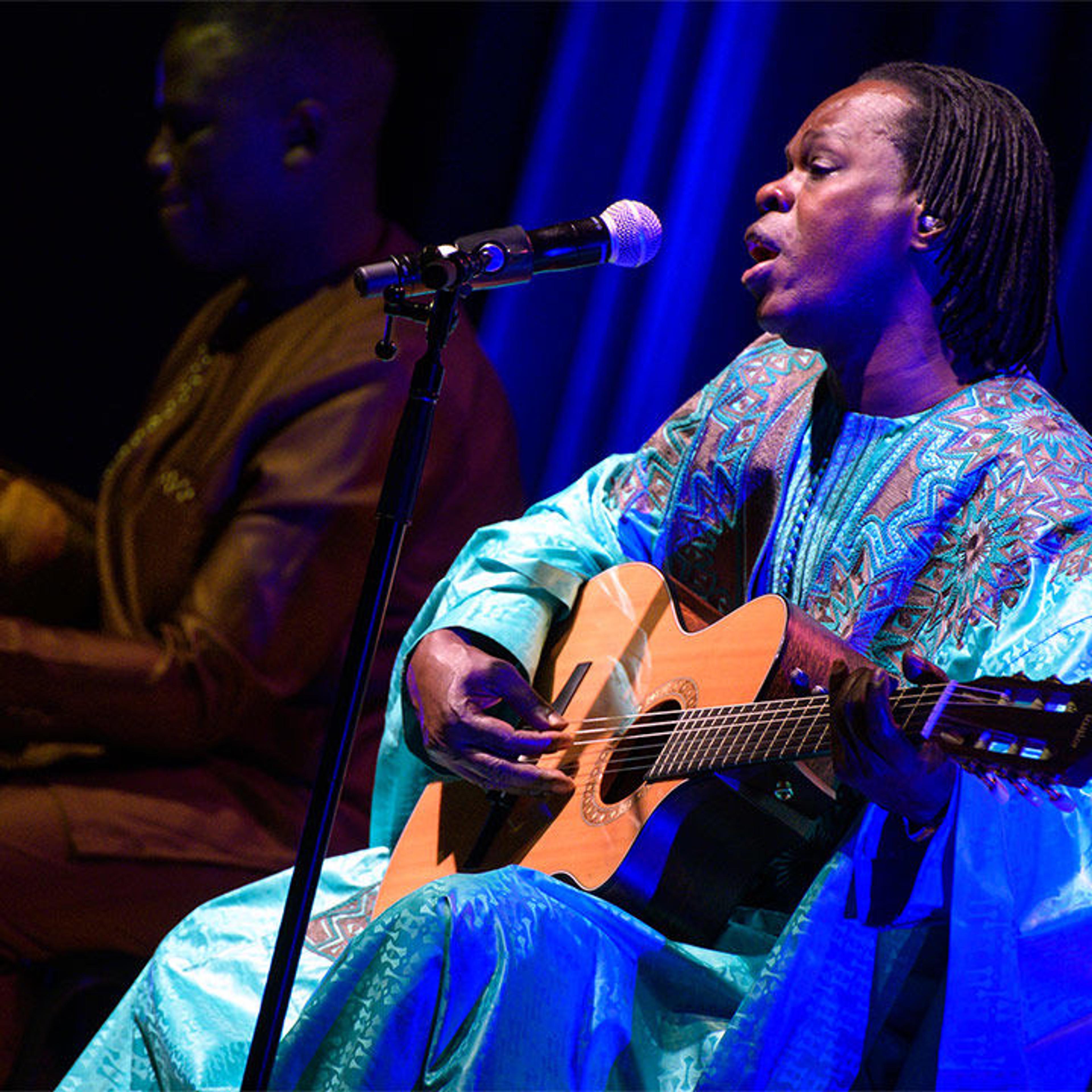 Senegalese singer Baaba Maal, in blue, performs an acoustic concert with Cheikh Ndiaye (left) at The Met.