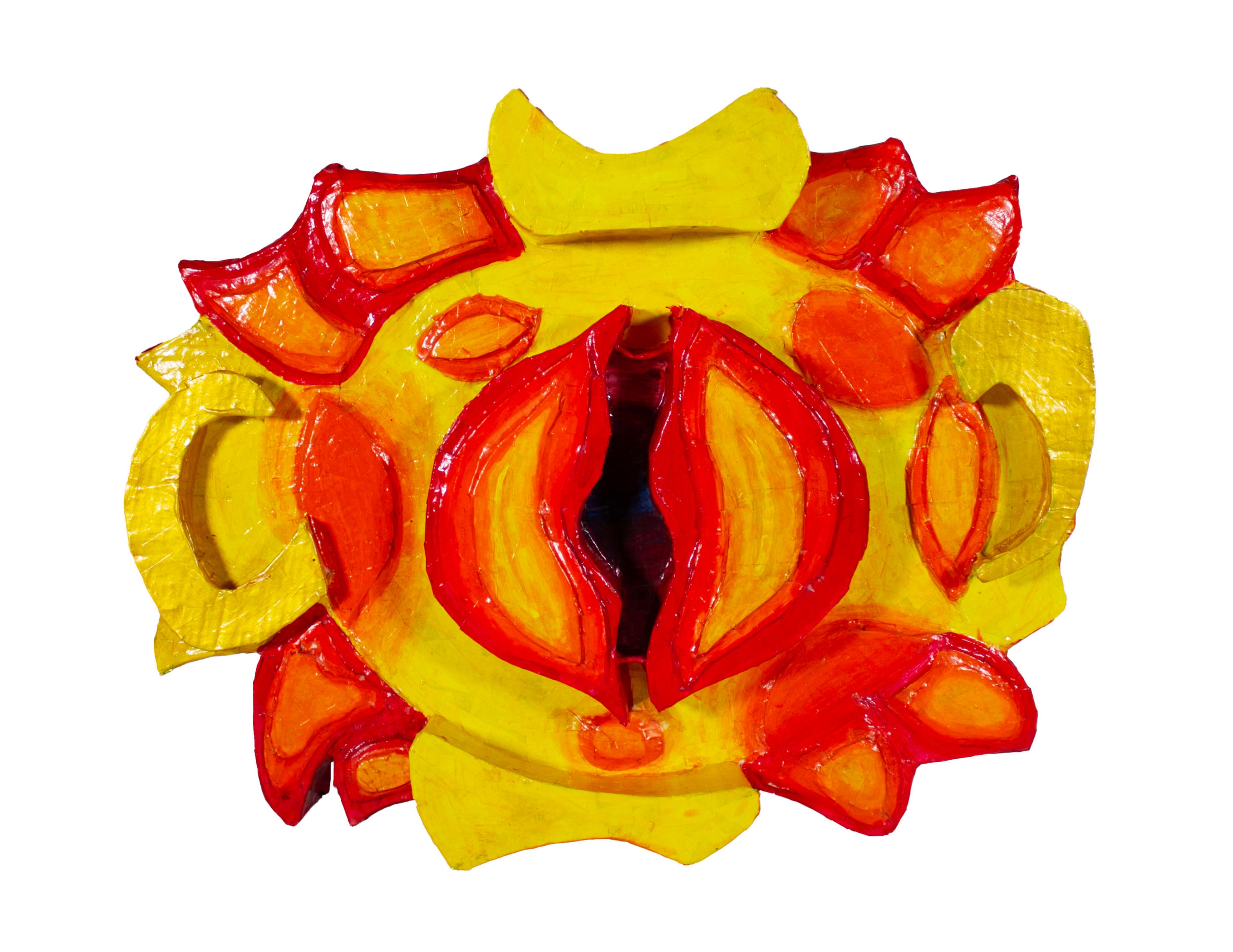 Recycled cardboard sculpture of a bright yellow flower fringed with bright red accents on the outer edges of the petals and a red orange bloom at the center.