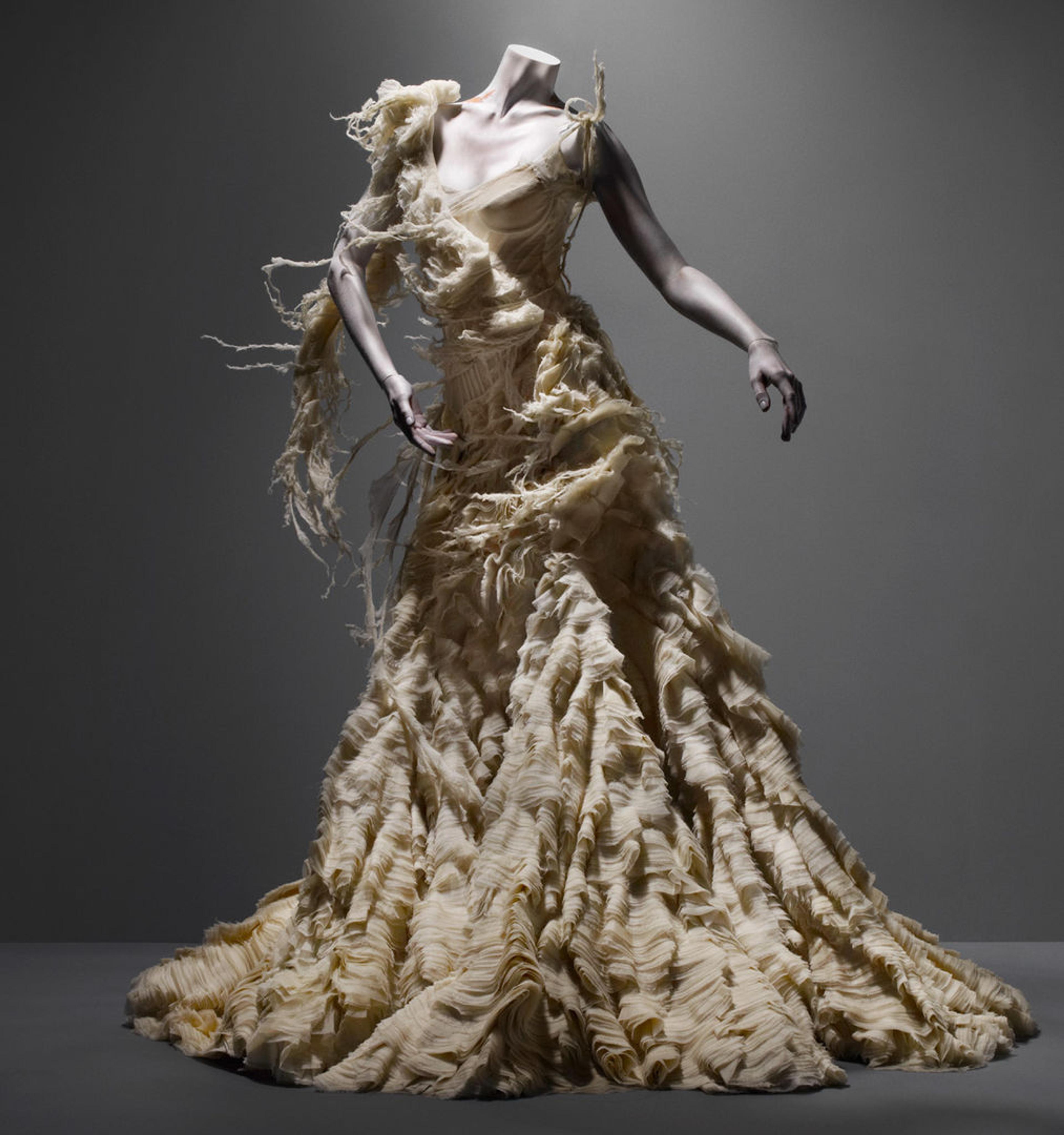 A couture gown by Alexander McQueen against a dark grey background