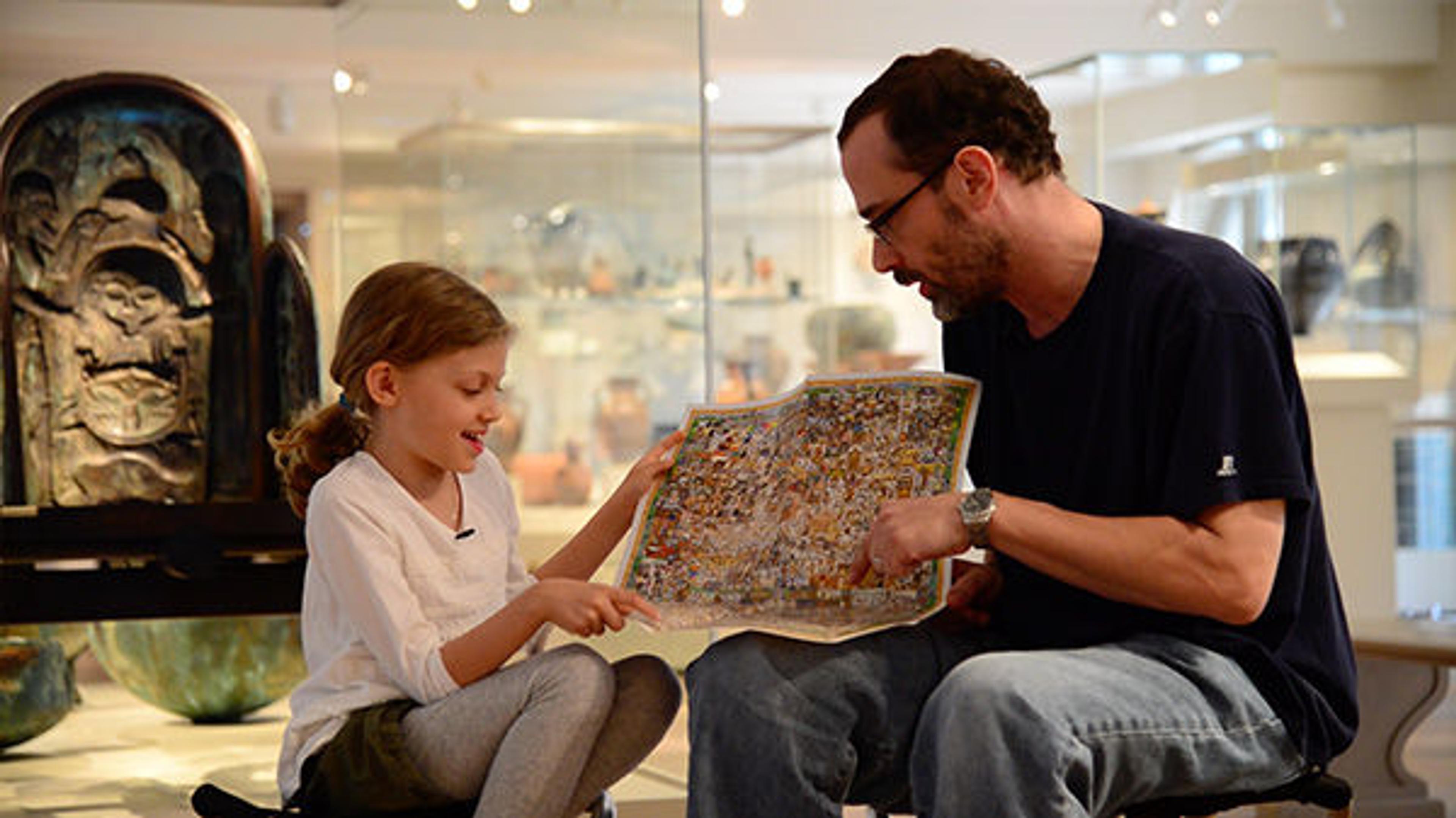 John Kerschbaum and his daughter look at the Met's Family Map