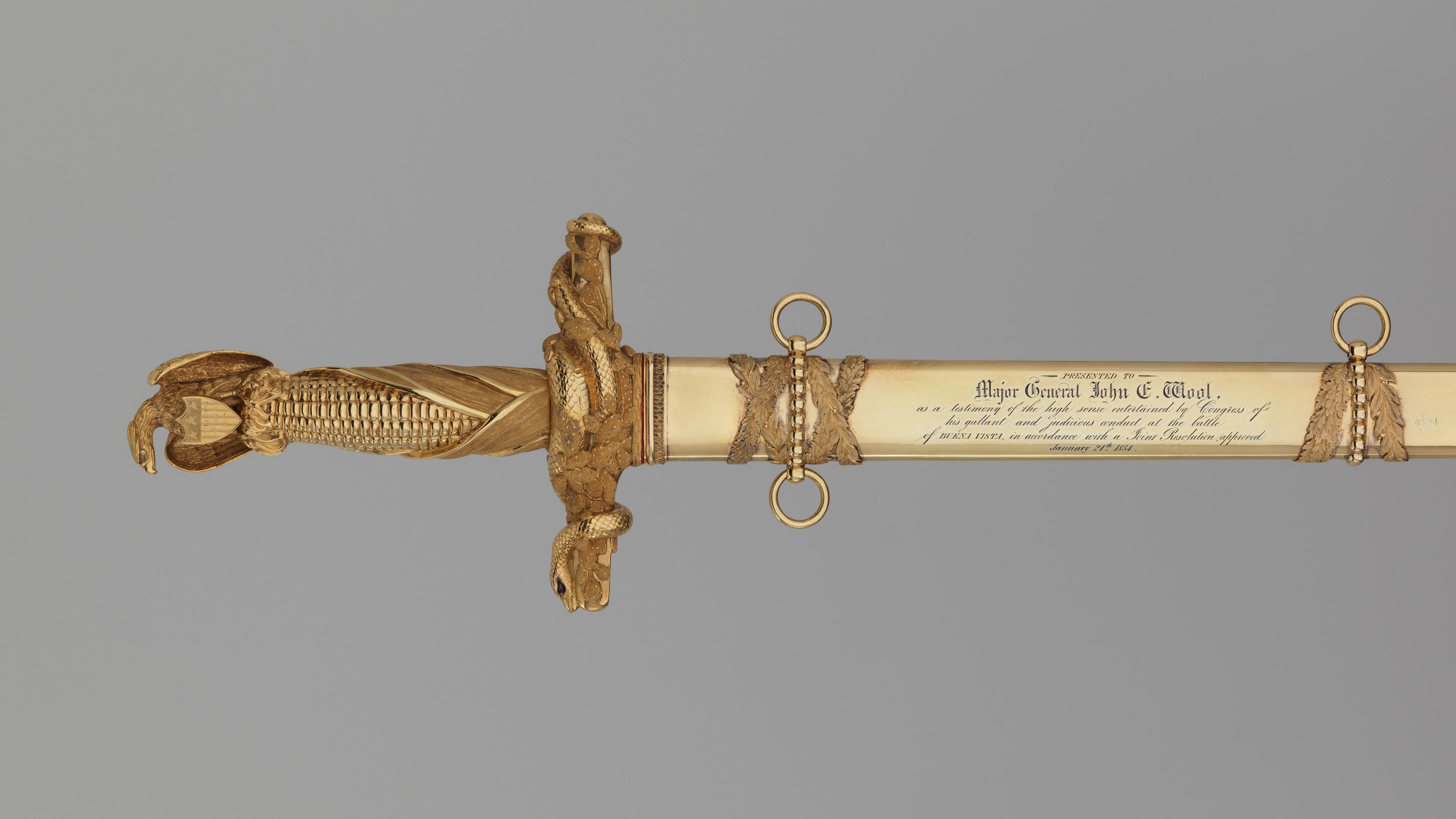 Congressional Presentation Sword and Scabbard of Major General John E. Wool made out of Steel, gold, brass, diamonds, rubies. The massive gold hilt incorporates the American eagle as the pommel, an ear of corn for the grip, and a cactus branch entwined with snakes (for Mexico) as the cross-guard.