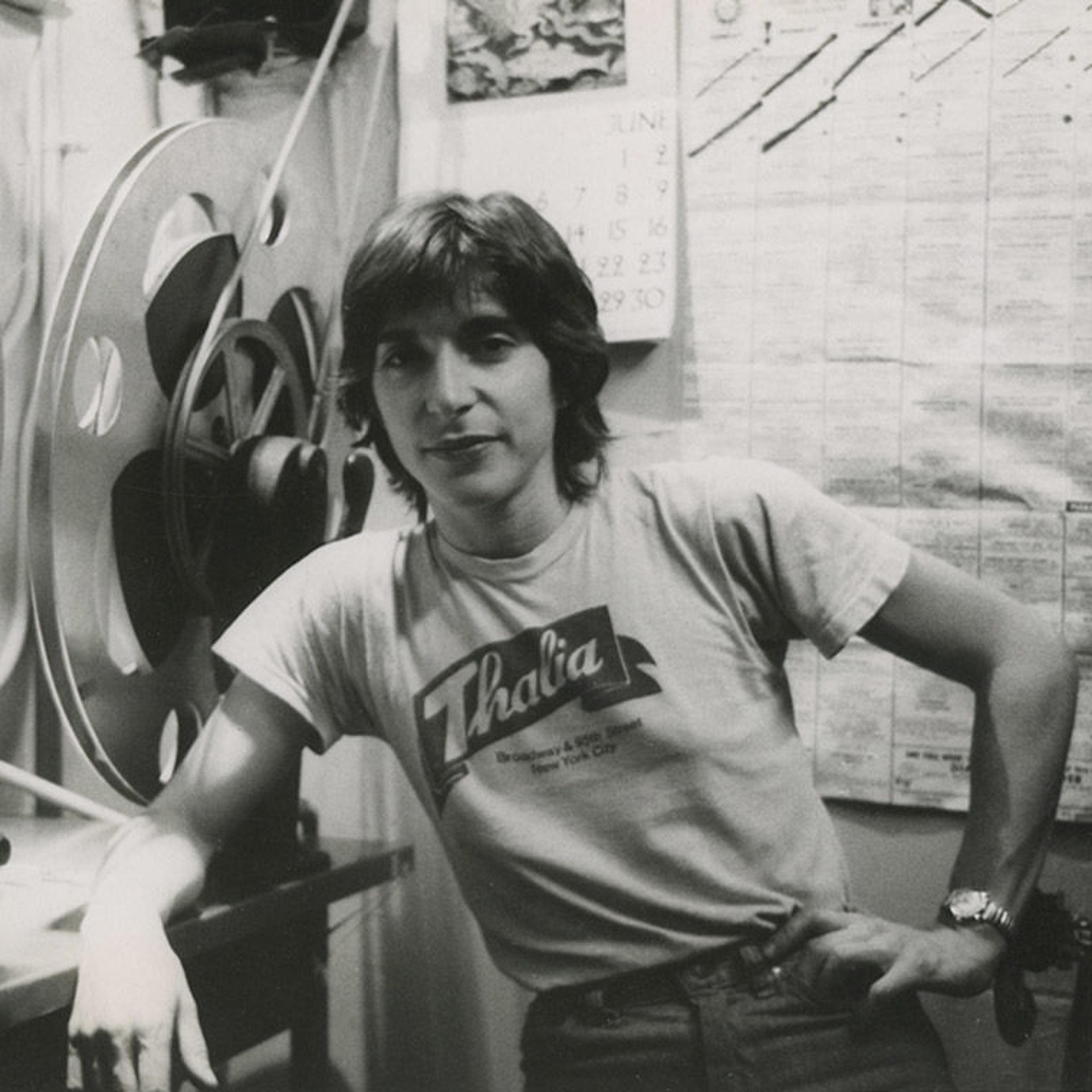 A black-and-white photograph of the author, Robin Schwalb, standing beside a rewinder at the Thalia Theater in New York City, circa 1978.