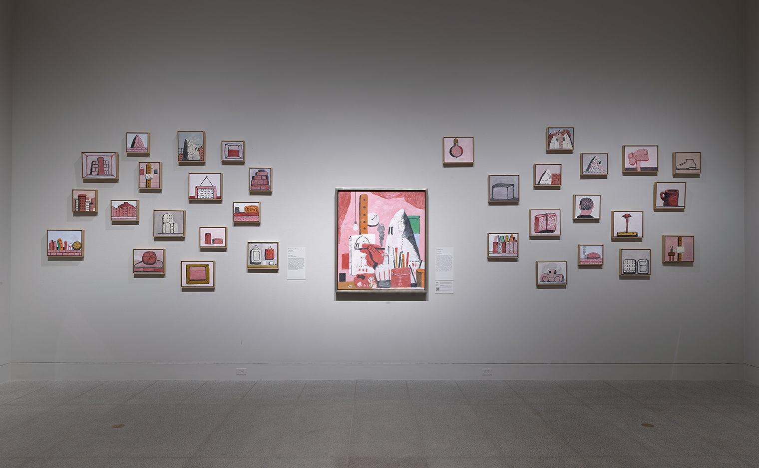 Gallery shot of a collection of Guston paintings.
