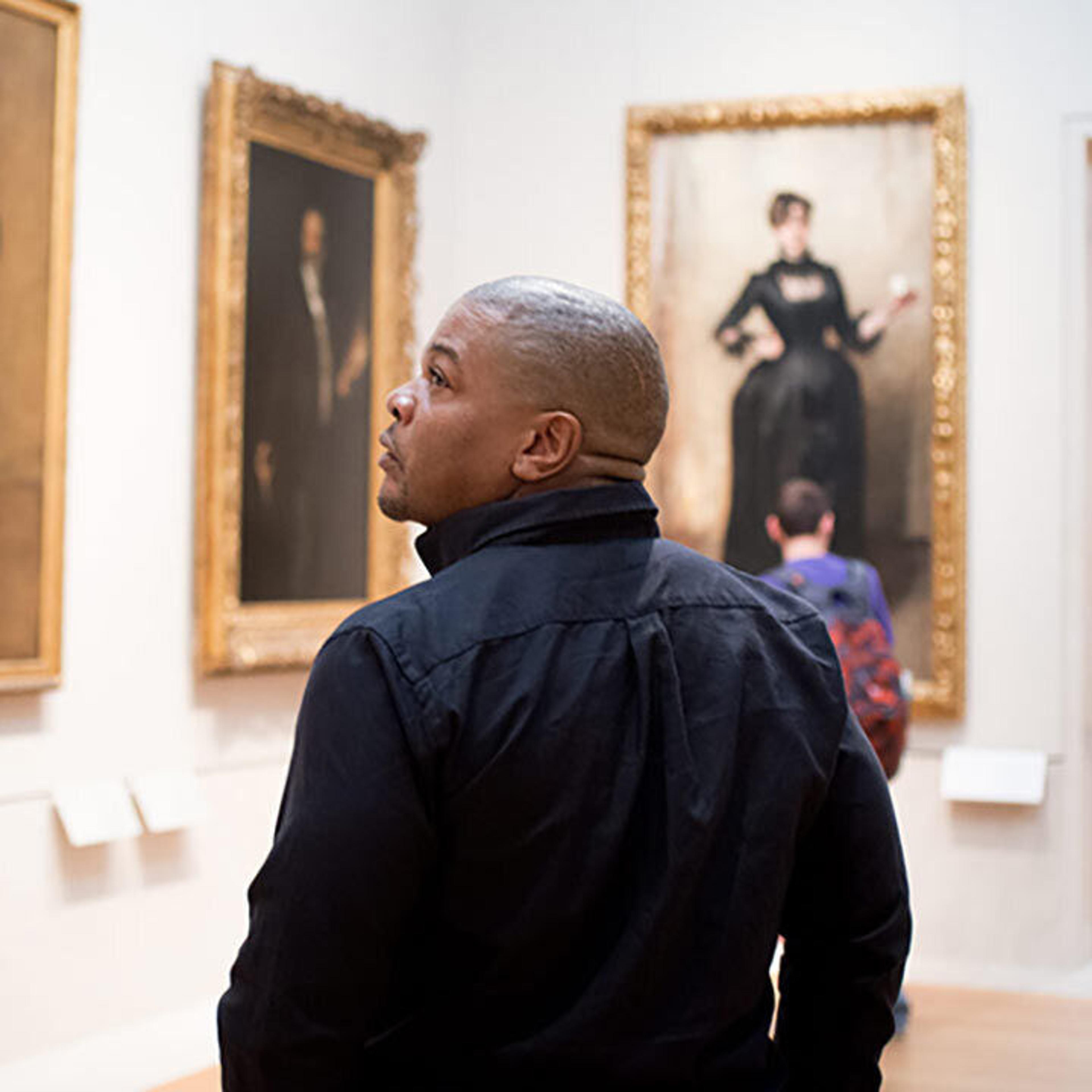 The artist Kehinde Wiley walks through a gallery of portraits by Sargent