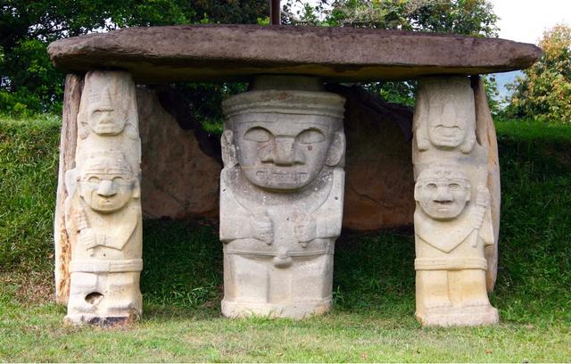 Stone carvings of large figures at a tomb