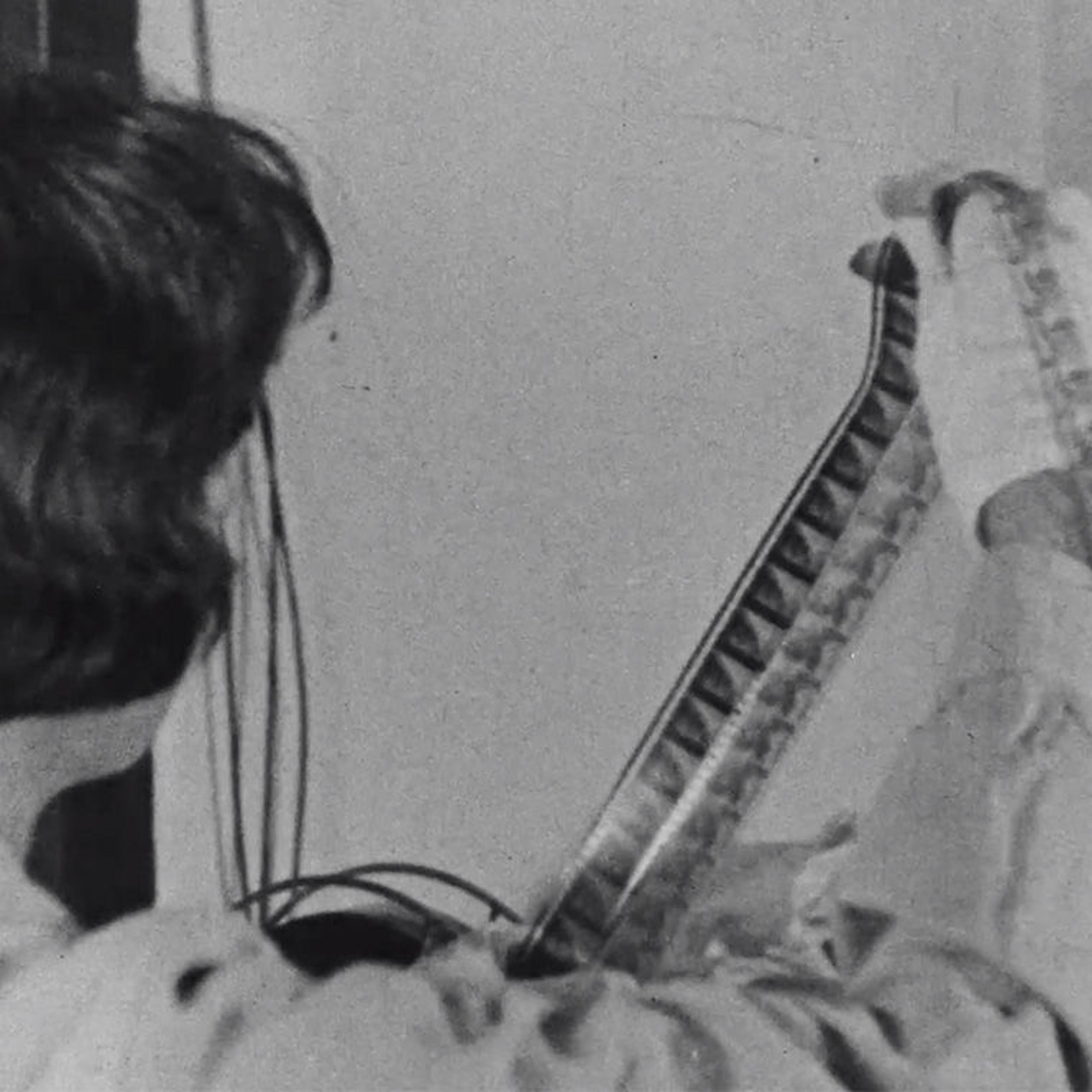 A woman examines a film strip