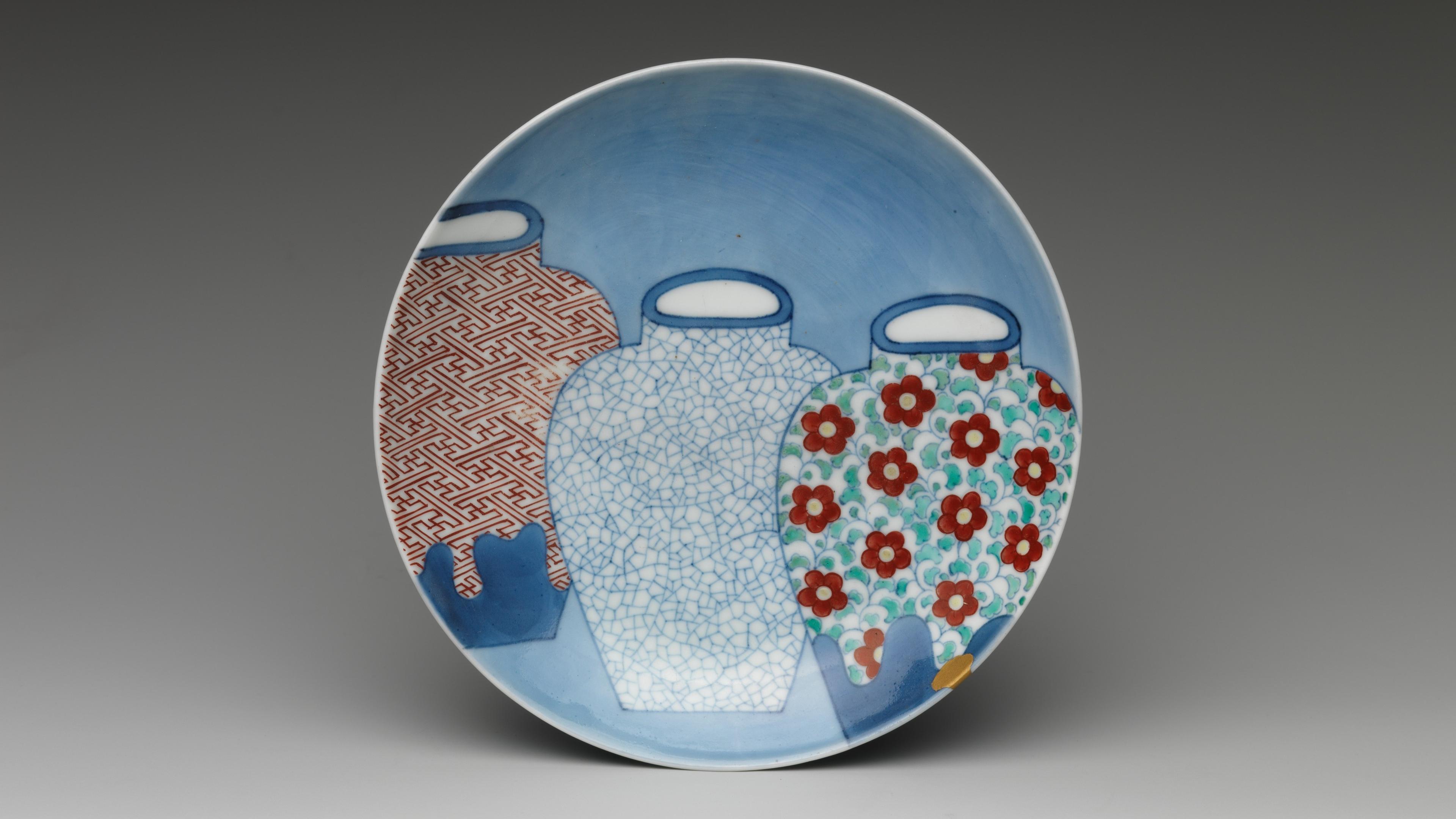 A ceramic dish adorned with the image of with three highly decorated vessels