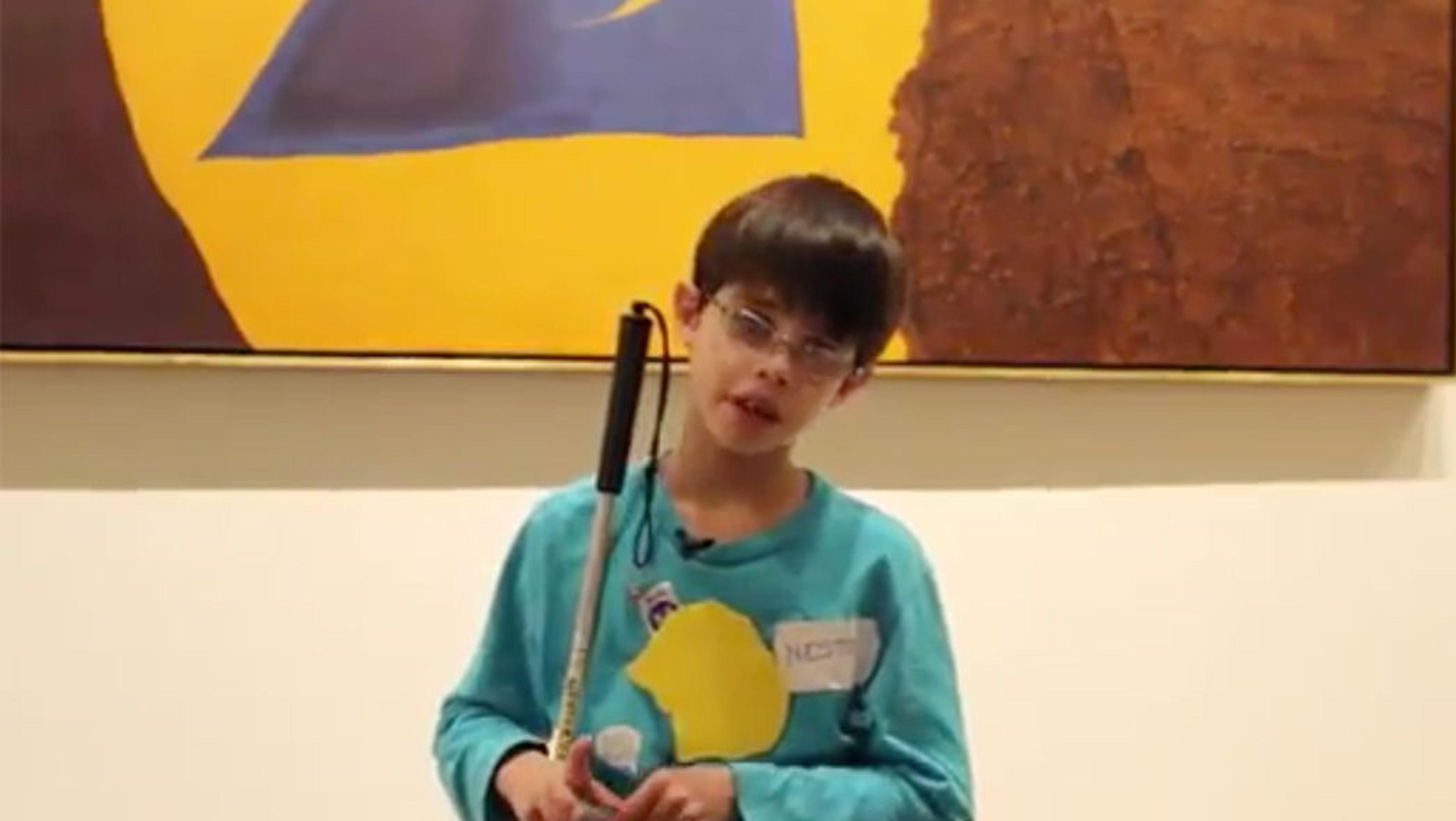 Nestor, age 10, speaks in front of an artwork by the artist Miro